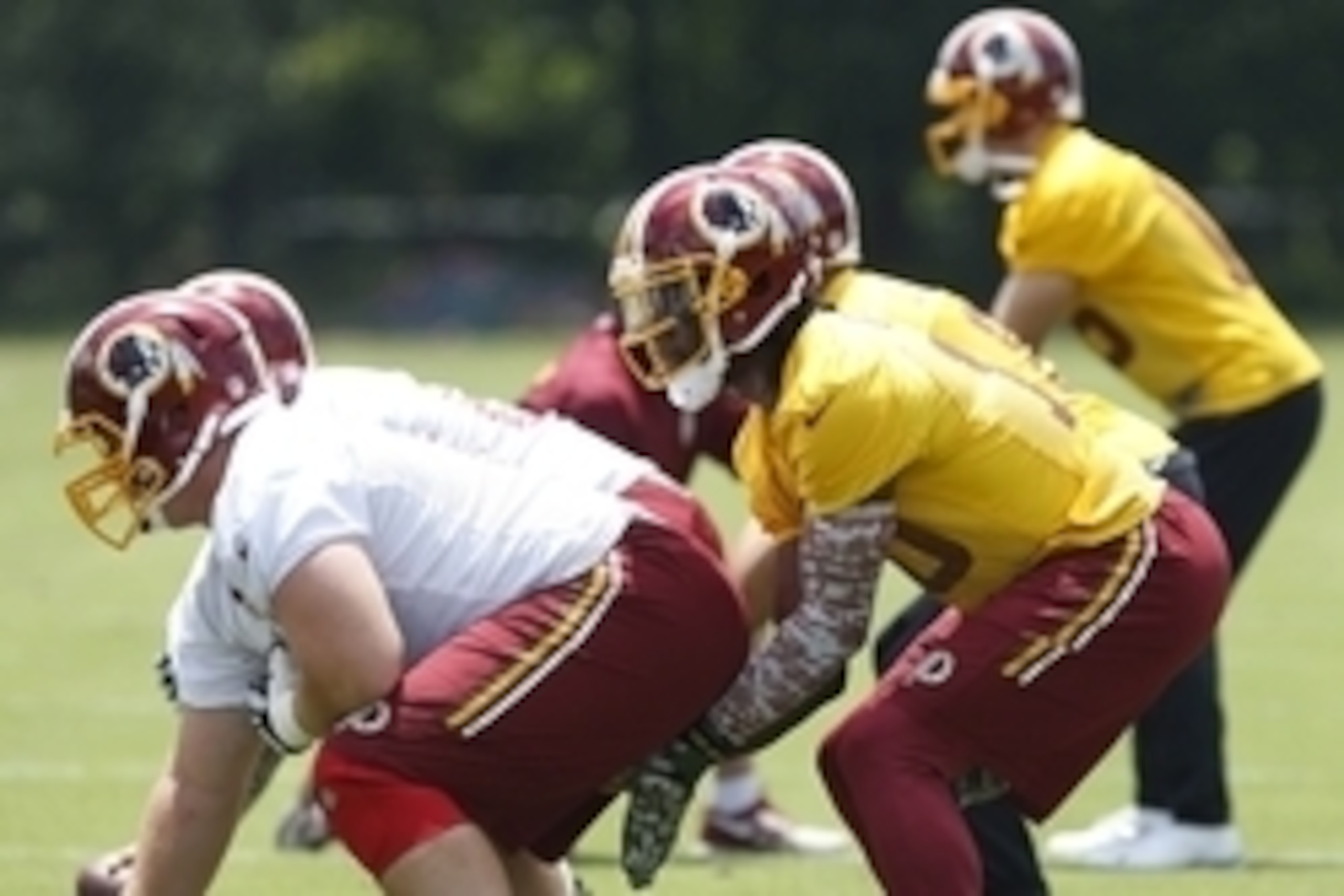 Jun 16, 2015; Ashburn, VA, USA; Washington Redskins quarterback Robert Griffin III (10) lines up under center during drills as part of day one of Redskins Minicamp at Redskins Park. Mandatory Credit: Geoff Burke-USA TODAY Sports