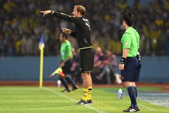 Head coach Thomas Tuchel (C) of Germany's football club Borussia Dortmund instructs players during a friendly match with Japan's club Kawasaki Frontale in Kawasaki, suburb of Tokyo, on July 7, 2015.      AFP PHOTO / Toru YAMANAKA        (Photo credit shou