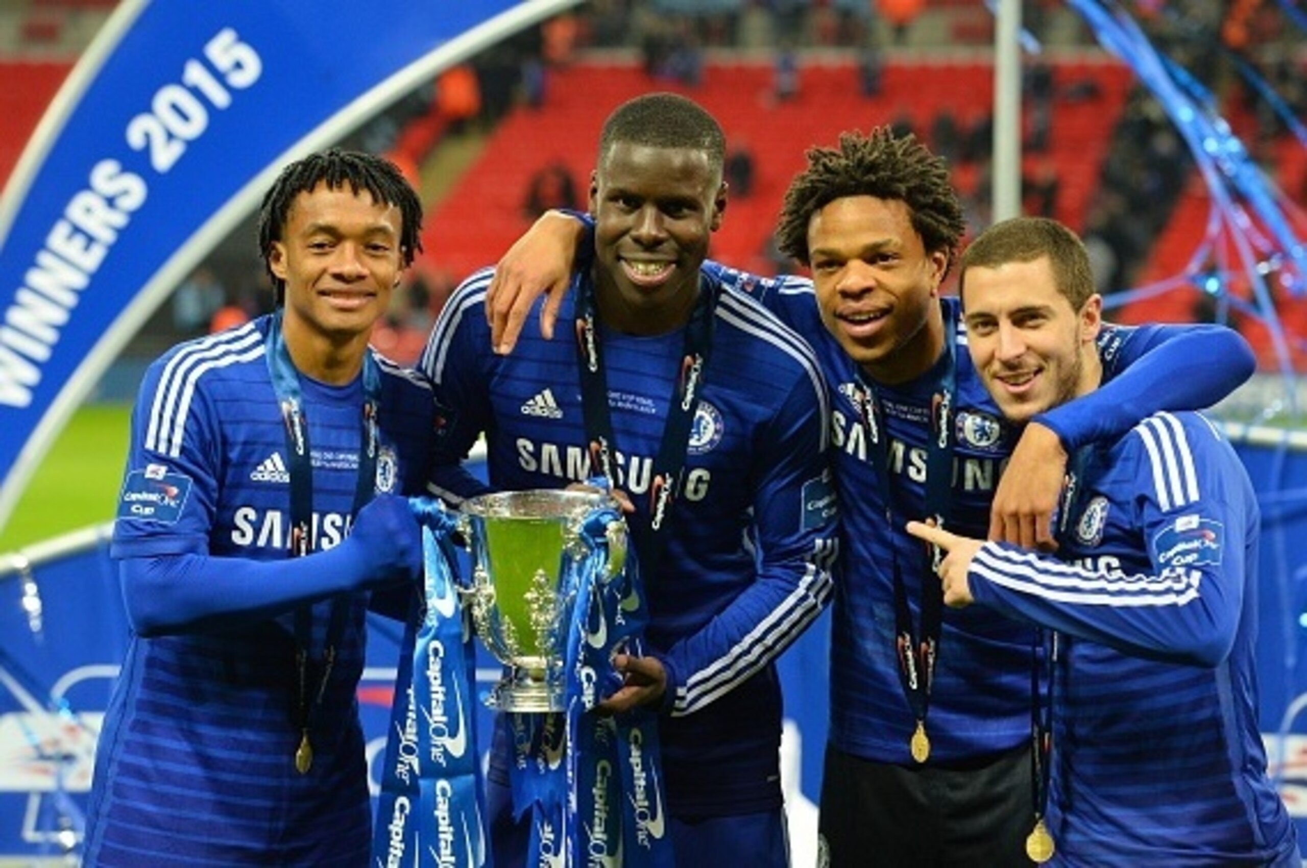 Chelsea's Colombian midfielder Juan Cuadrado (L), Chelsea's French defender Kurt Zouma, Chelsea's French striker Loic Remy (2nd R) and Chelsea's Belgian midfielder Eden Hazard (R) celebrate with the trophy during the presentation after Chelsea won the Lea Chelsea's Colombian midfielder Juan Cuadrado (L), Chelsea's French defender Kurt Zouma, Chelsea's French striker Loic Remy (2nd R) and Chelsea's Belgian midfielder Eden Hazard (R) celebrate with the trophy during the presentation after Chelsea won the Lea