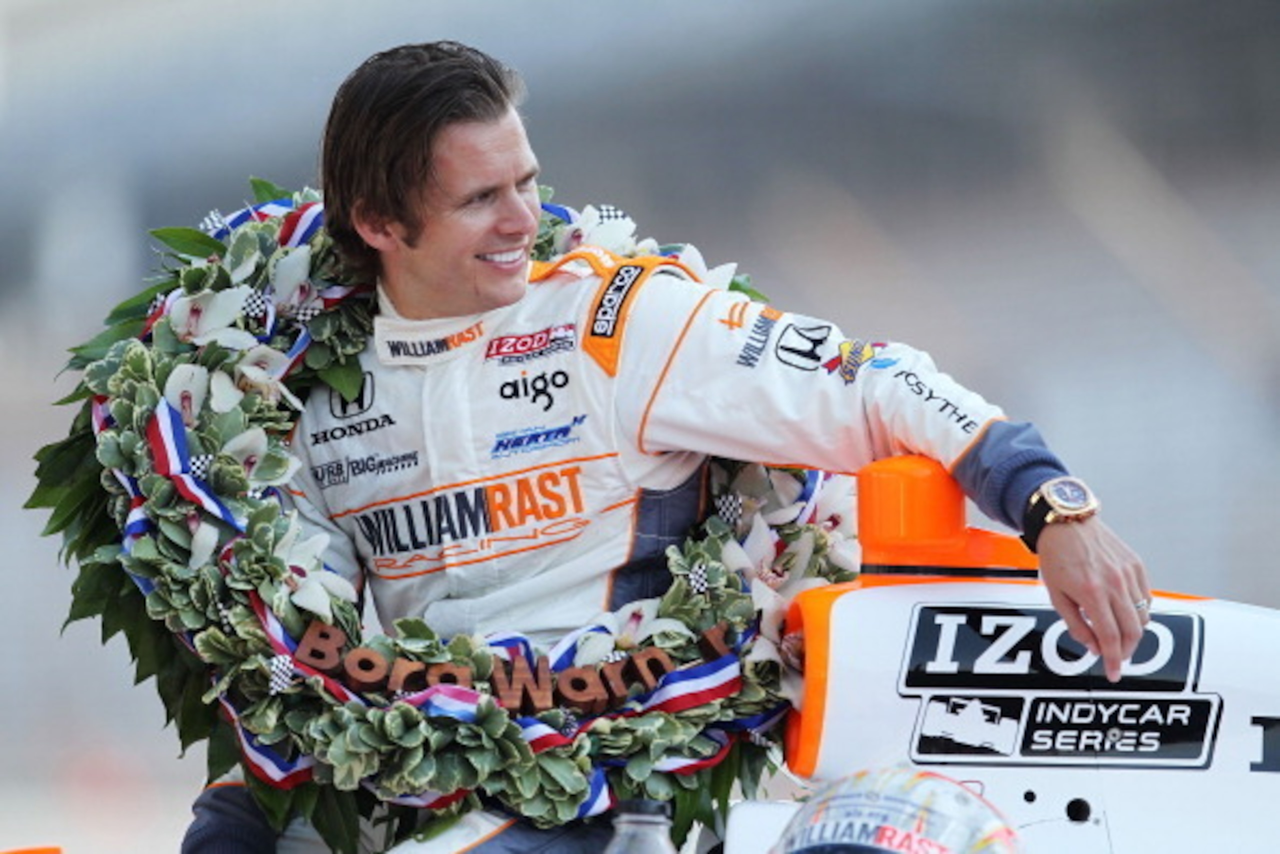 INDIANAPOLIS, IN - MAY 30:  Dan Wheldon of England, driver of the #98 William Rast-Curb/Big Machine Dallara Honda waits at his car during the 95th Indianapolis 500 Mile Race Trophy Presentation at Indianapolis Motor Speedway on May 30, 2011 in Indianapoli