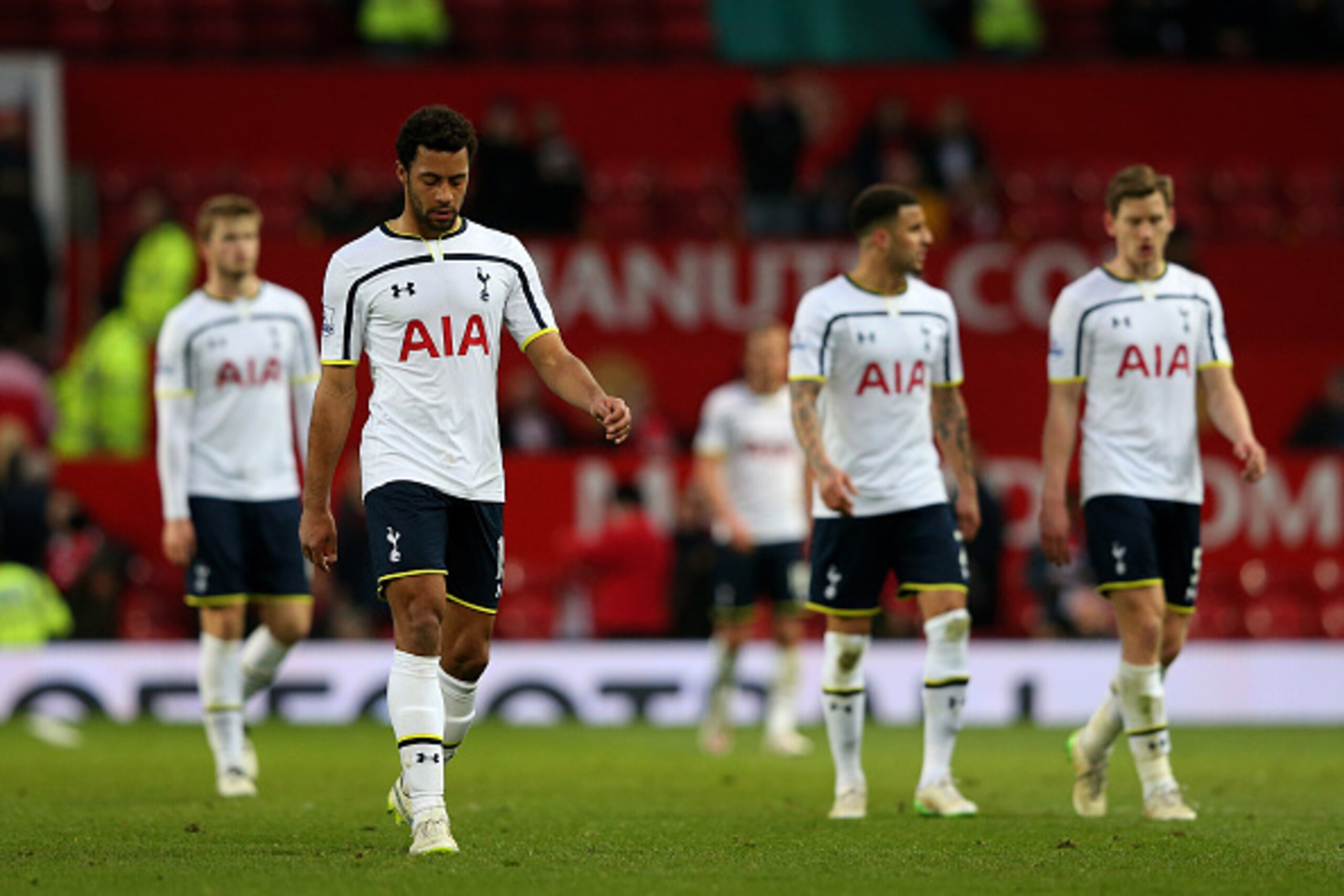 MANCHESTER, ENGLAND - MARCH 15:  A dejected Mousa Dembele of Spurs and teammates walk off the pitch following their team's 3-0 defeat during the Barclays Premier League match between Manchester United and Tottenham Hotspur at Old Trafford on March 15, 201