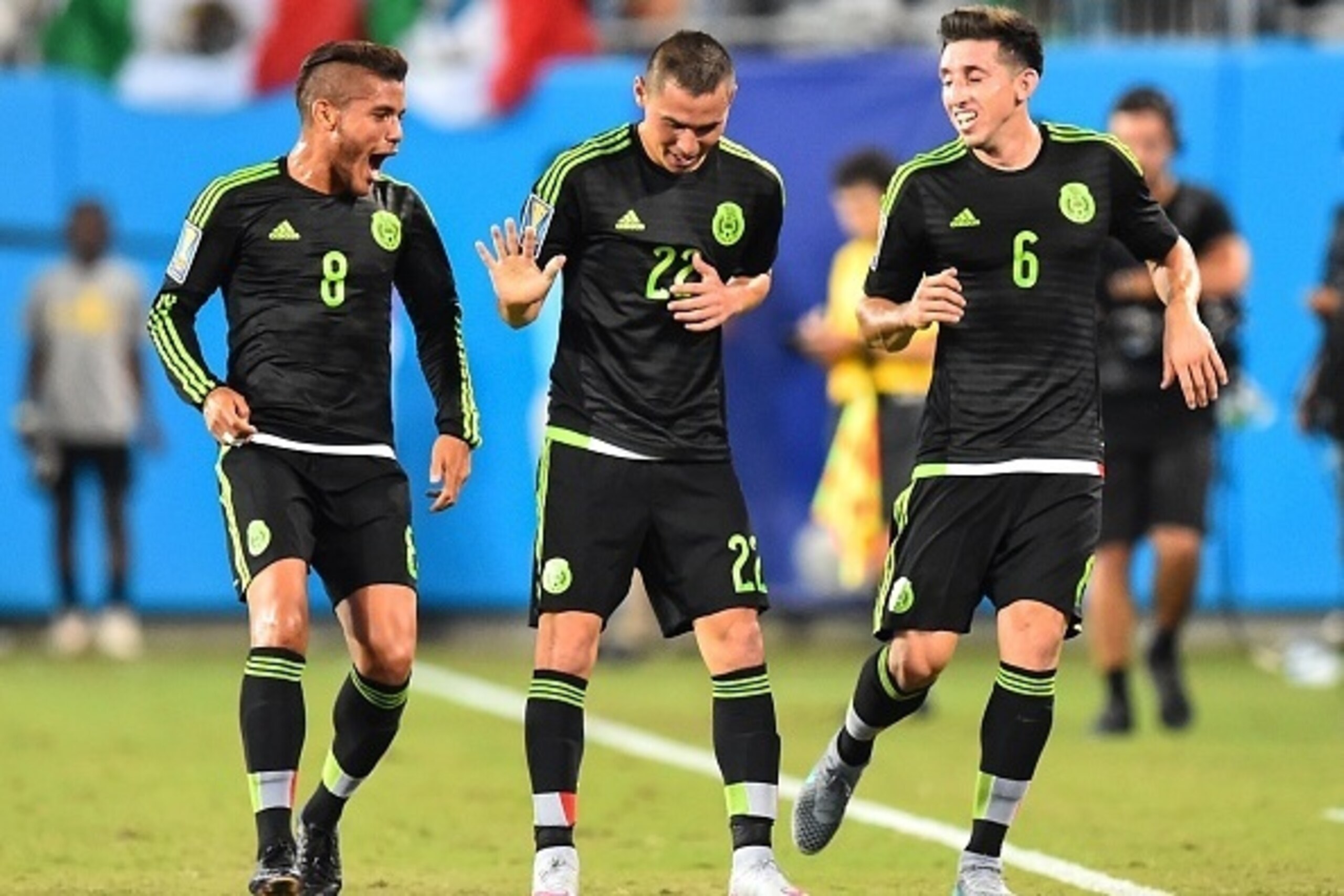 Mexico's Paul Aguilar (C) celebrates scoring against Trinidad and Tobago with Jonathan Dos Santos (L) and Hector Herrera during a CONCACAF Gold Cup Group C match  in Charlotte, North Carolina, on July 15, 2015.    AFP PHOTO/NICHOLAS KAMM        (Photo cre