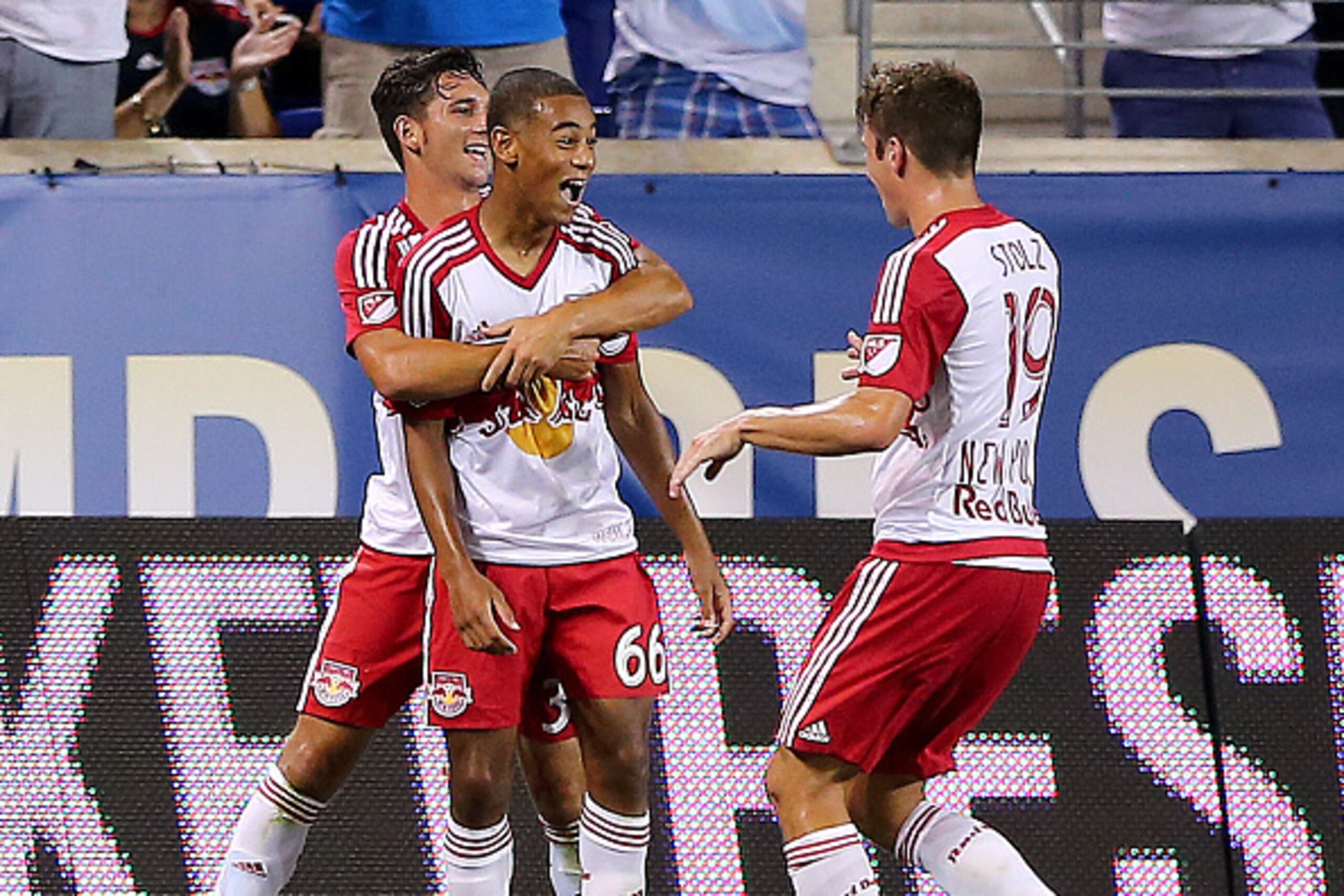 HARRISON, NJ - JULY 22:  Tyler Adams #66 of the New York Red Bulls is congratulated by teammates Dan Metzger #30 and Leo Stolz #19 after Adams scored in the second half against Chelsea during the International Champions Cup at Red Bull Arena on July 22, 2