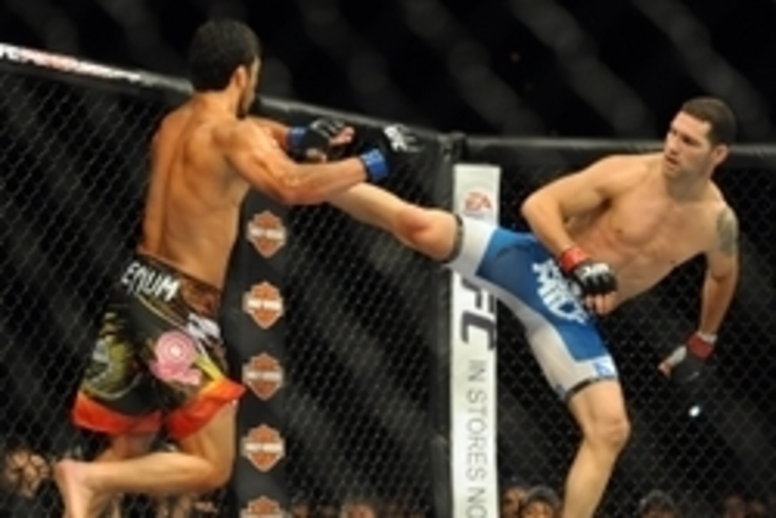 Jul 5, 2014; Las Vegas, NV, USA; Chris Weidman (red gloves) lands a kick to Lyoto Machida (blue gloves) during a middleweight title fight at Mandalay Bay Events Center. Mandatory Credit: Stephen R. Sylvanie-USA TODAY Sports