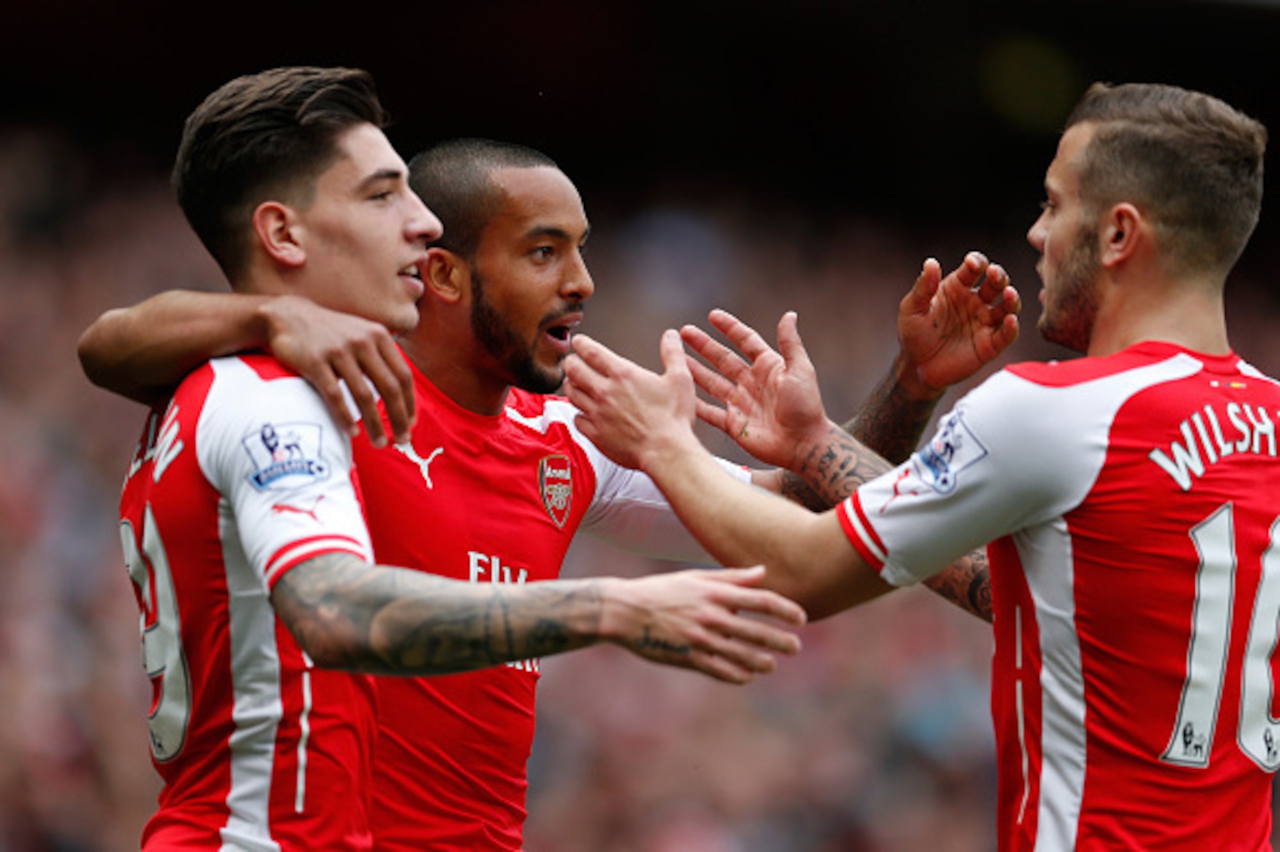 LONDON, ENGLAND - MAY 24: Theo Walcott (C) of Arsenal celebrates scoring his team's second goal with his team mate Hector Bellerin (L) and Jack Wilshere (R) during the Barclays Premier League match between Arsenal and West Bromwich Albion at Emirates Stad