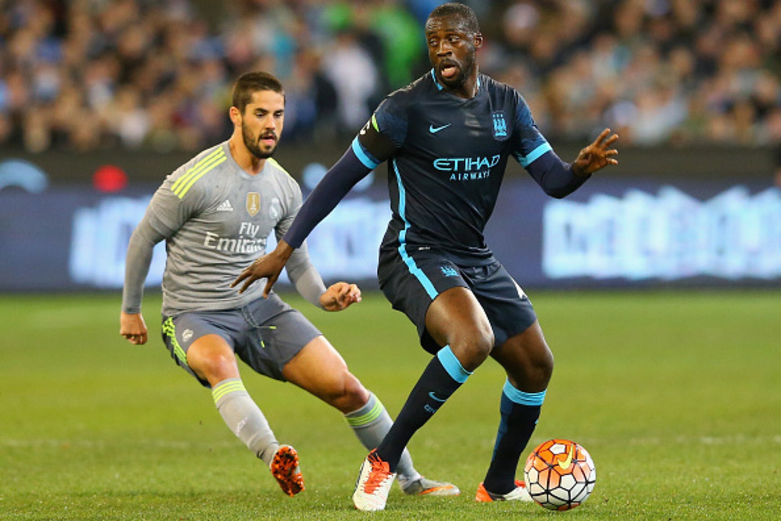 MELBOURNE, AUSTRALIA - JULY 24:  Isco of Real Madrid and Yaya Toure of Manchester City compete for the ball during the International Champions Cup match between Real Madrid and Manchester City at Melbourne Cricket Ground on July 24, 2015 in Melbourne, Aus