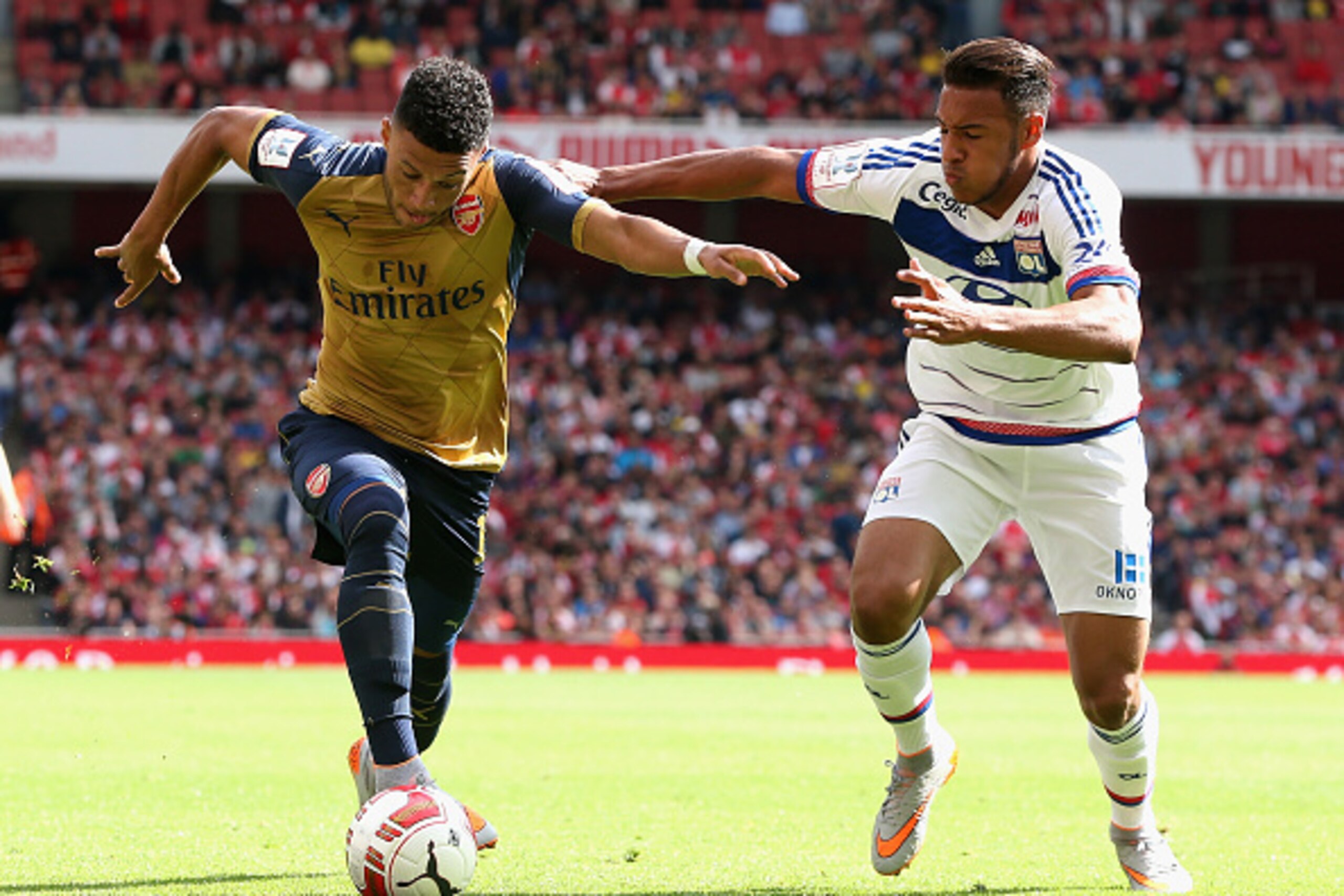 LONDON, ENGLAND - JULY 25:  Alex Oxlade-Chamberlain of Arsenal takes on Corentin Tolisso during the Emirates Cup match between Arsenal and Olympique Lyonnais at the Emirates Stadium on July 25, 2015 in London, England.  (Photo by David Rogers/Getty Images