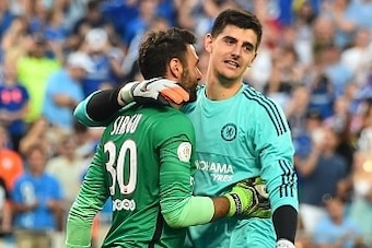 Chelsea goalkeeper Thibaut Courtois (R) and Paris Saint-Germain counterpart Salvatore Sirigu embrace after a penalty shootout during an International Champions Cup football match in Charlotte, North Carolina, on July 25, 2015.    AFP PHOTO/NICHOLAS KAMM  