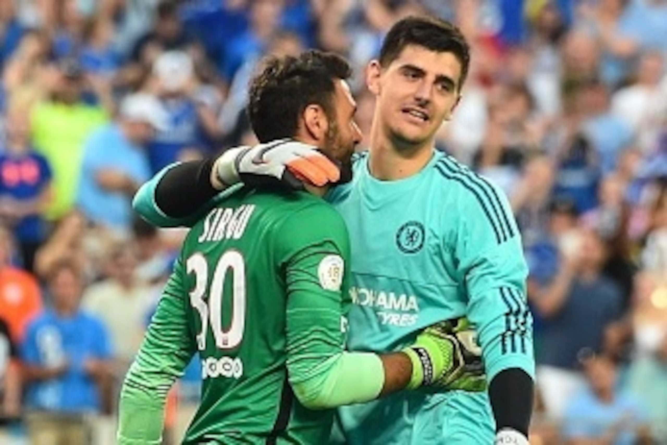 Chelsea goalkeeper Thibaut Courtois (R) and Paris Saint-Germain counterpart Salvatore Sirigu embrace after a penalty shootout during an International Champions Cup football match in Charlotte, North Carolina, on July 25, 2015.    AFP PHOTO/NICHOLAS KAMM  