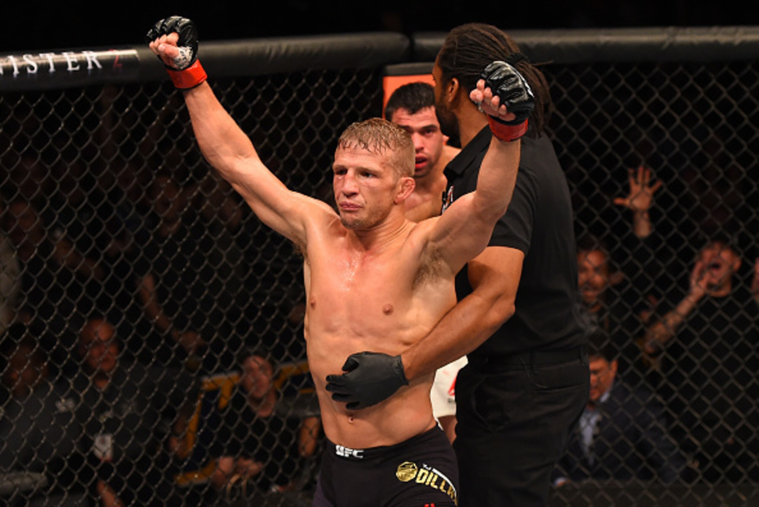 CHICAGO, IL - JULY 25:   TJ Dillashaw reacts after his TKO victory over Renan Barao of Brazil in their UFC bantamweight championship bout during the UFC event at the United Center on July 25, 2015 in Chicago, Illinois. (Photo by Jeff Bottari/Zuffa LLC/Zuf