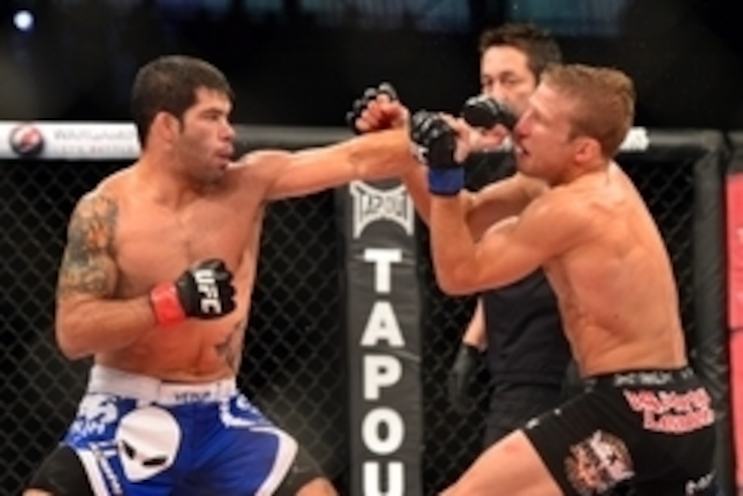 Oct 9, 2013; Barueri, Sao Paulo, Brazil; Raphael Assuncao  (blue shorts) fights against  TJ Dillashaw (black shorts) during UFC Fight Night 29 at Jose Correa Arena. Mandatory Credit: Jason Silva-USA TODAY Sports