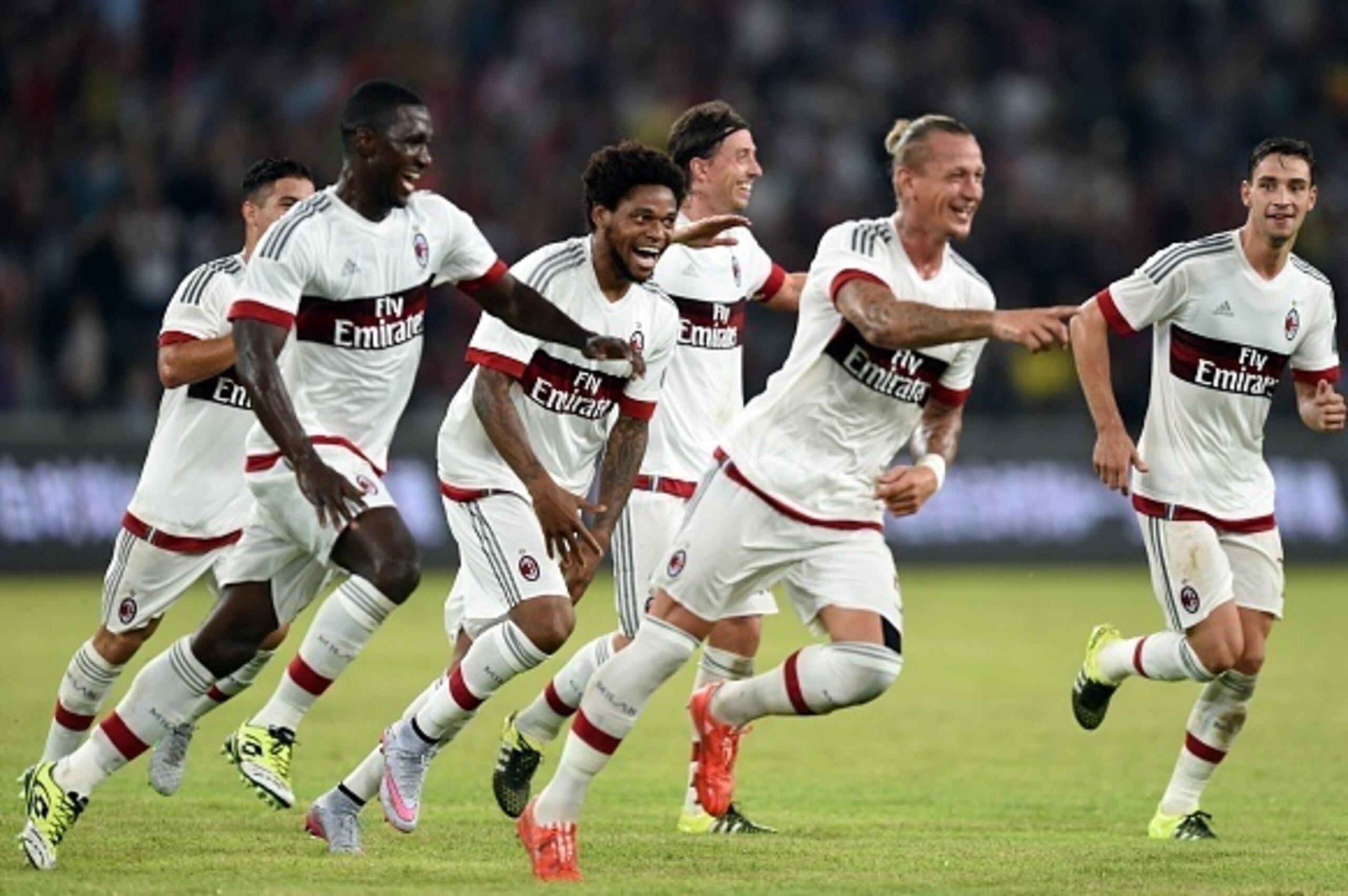 AC Milan's players celebrate with French defender Philippe Mexes (2R) after scoring a goal during the International Champions Cup football match between AC Milan and  Inter Milan in Shenzhen on July 25, 2015.  AFP PHOTO / JOHANNES EISELE        (Photo cre