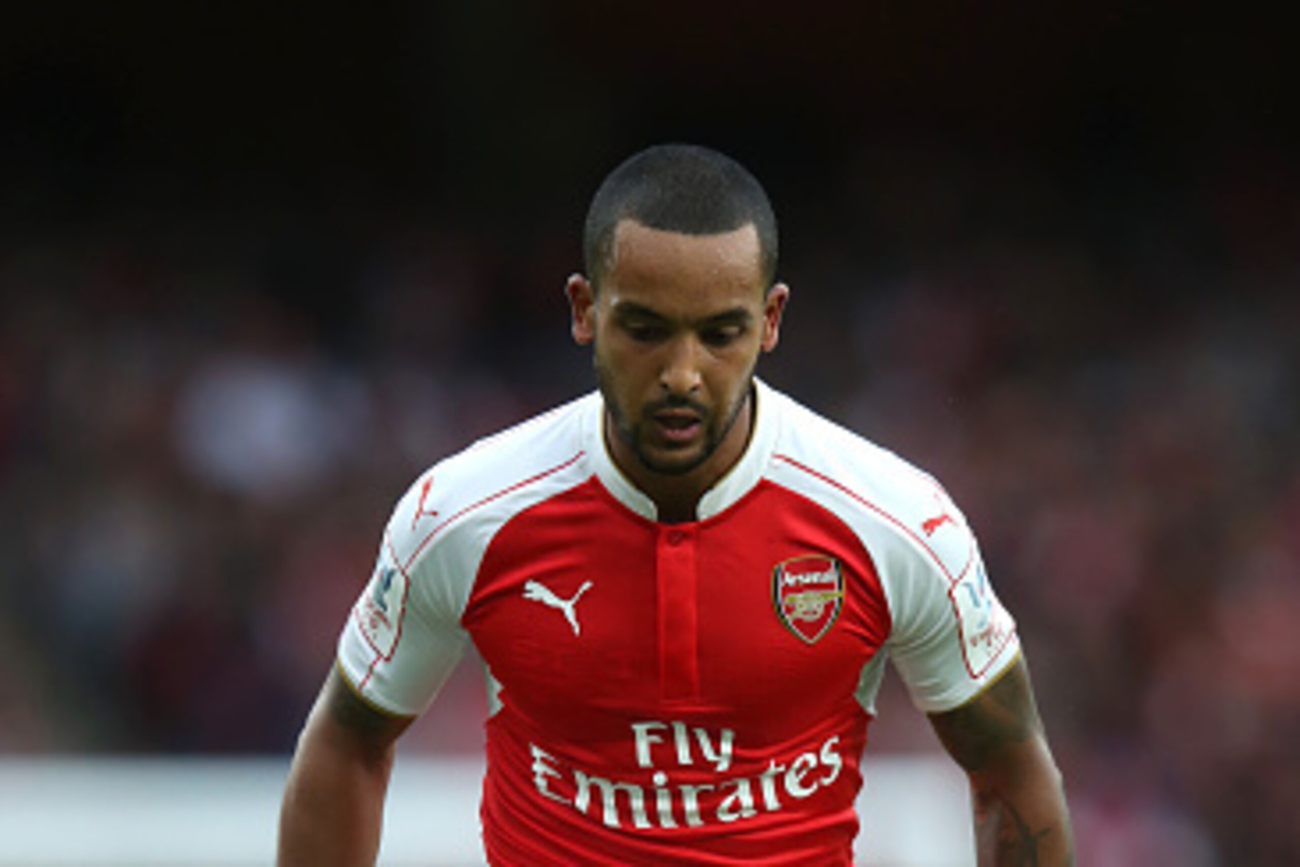 LONDON, ENGLAND - JULY 26:  Theo Walcott of Arsenal runs with the ball during the Emirates Cup match between Arsenal and VfL Wolfsburg at the Emirates Stadium on July 26, 2015 in London, England.  (Photo by David Rogers/Getty Images)