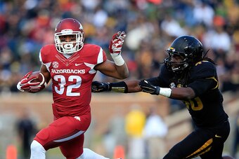 COLUMBIA, MO - NOVEMBER 28:  Jonathan Williams #32 of the Arkansas Razorbacks carries the ball as Clarence Green #40 of the Missouri Tigers defends during the game at Faurot Field/Memorial Stadium on November 28, 2014 in Columbia, Missouri.  (Photo by Jam