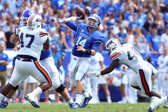 LEXINGTON, KY - AUGUST 30:  Patrick Towles #14 of the Kentucky Wildcats throws a pass during the game against the Tennessee- Martin Skyhawks at Commonwealth Stadium on August 30, 2014 in Lexington, Kentucky.  (Photo by Andy Lyons/Getty Images)