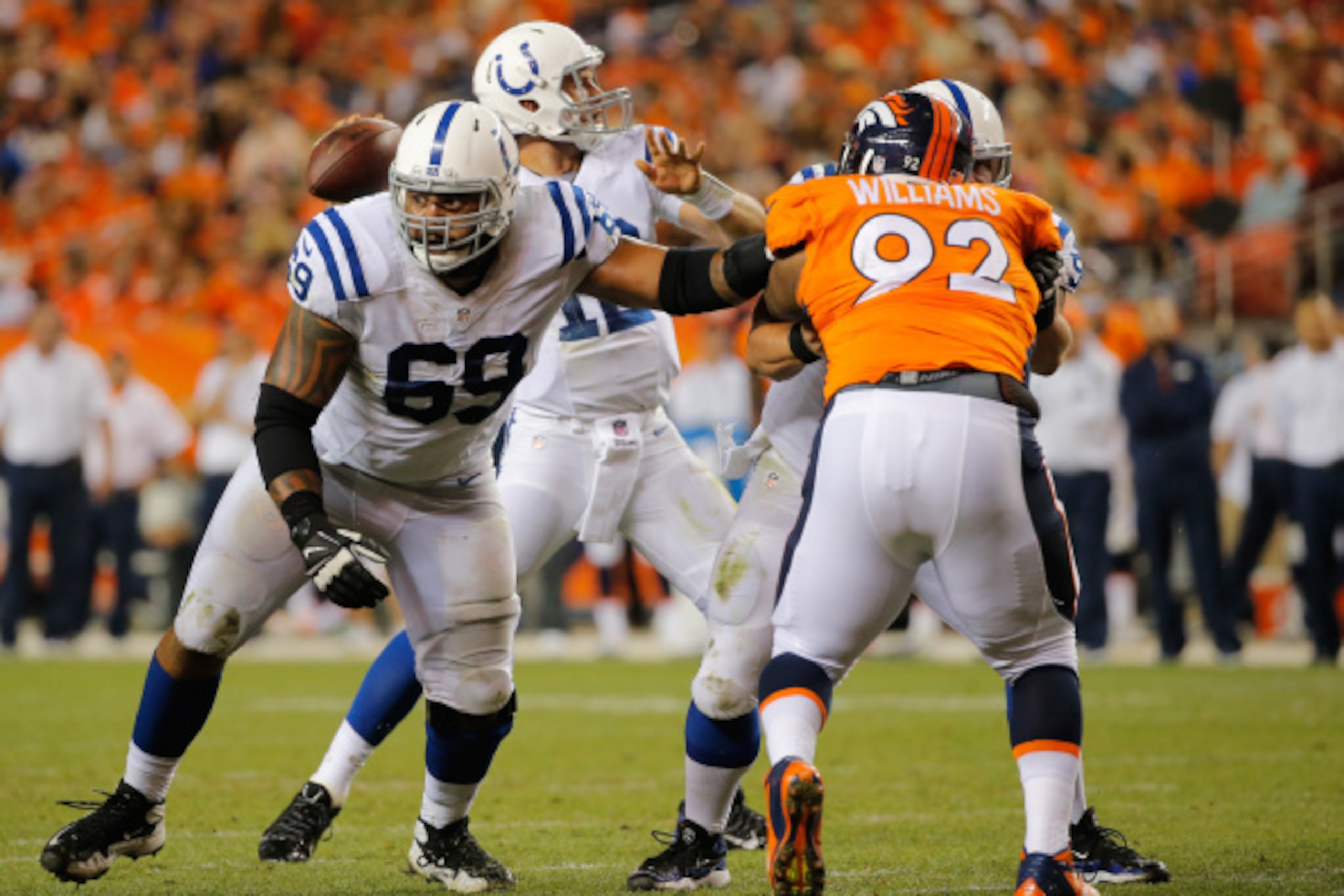 DENVER, CO - SEPTEMBER 07:  Offensive guard Hugh Thornton #69 of the Indianapolis Colts defends the line of scrimmage for quarterback Andrew Luck #12 of the Indianapolis Colts as center A.Q. Shipley #53 of the Indianapolis Colts blocks defensive tackle Sy
