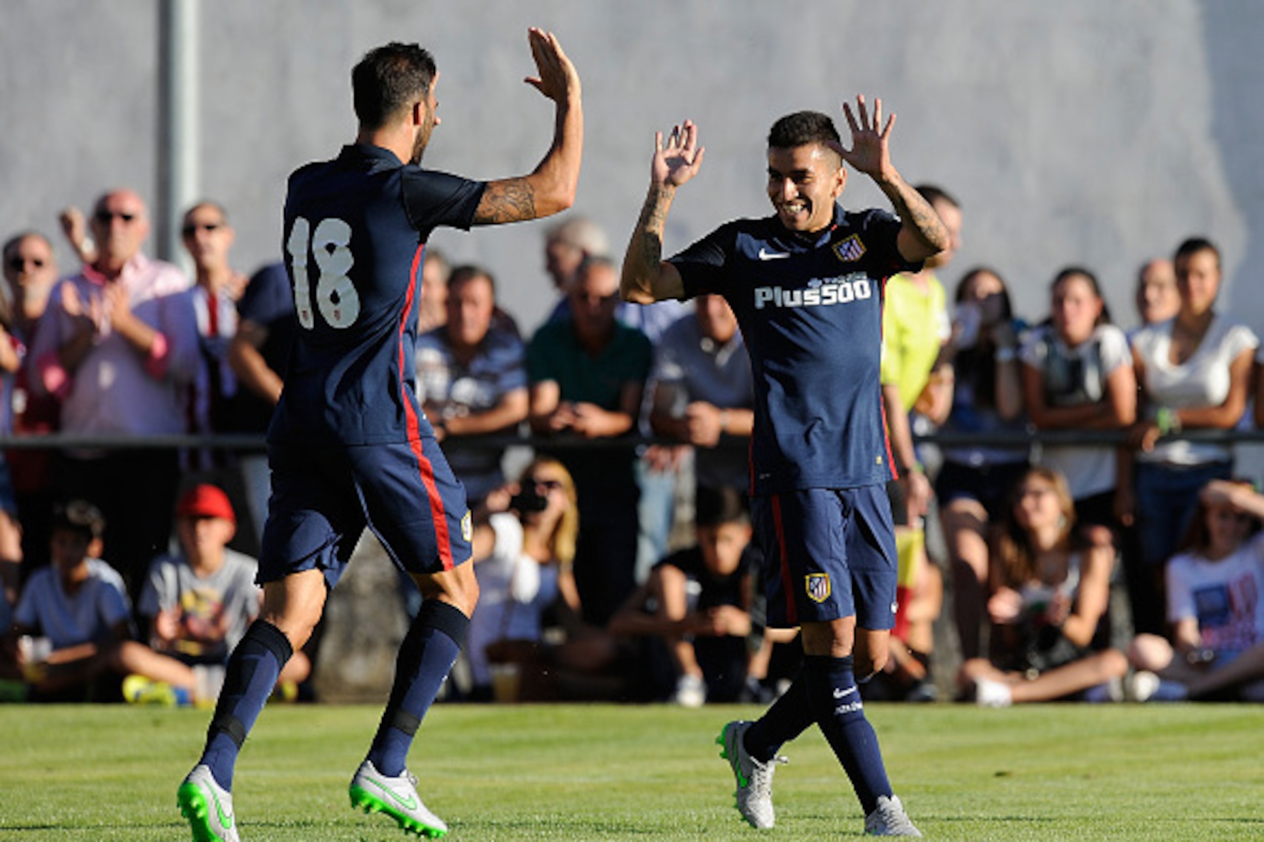 BURGO DE OSMA, SPAIN - JULY 25:  Angel Correa (R) of Club Atletico de Madrid celebrates with Jesus Gamez  after scoring his team's 2nd goal during the Jesus Gil y Gil Memorial pre-season friendly match between Numancia and Club Atletico de Madrid at the C