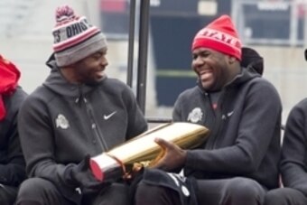 Jan 24, 2015; Columbus, OH, USA; Ohio State Buckeyes quarterback J.T. Barrett (16) hands the National Championship trophy to quarterback Cardale Jones (12) during the National Championship celebration at Ohio Stadium. Mandatory Credit: Greg Bartram-USA TO
