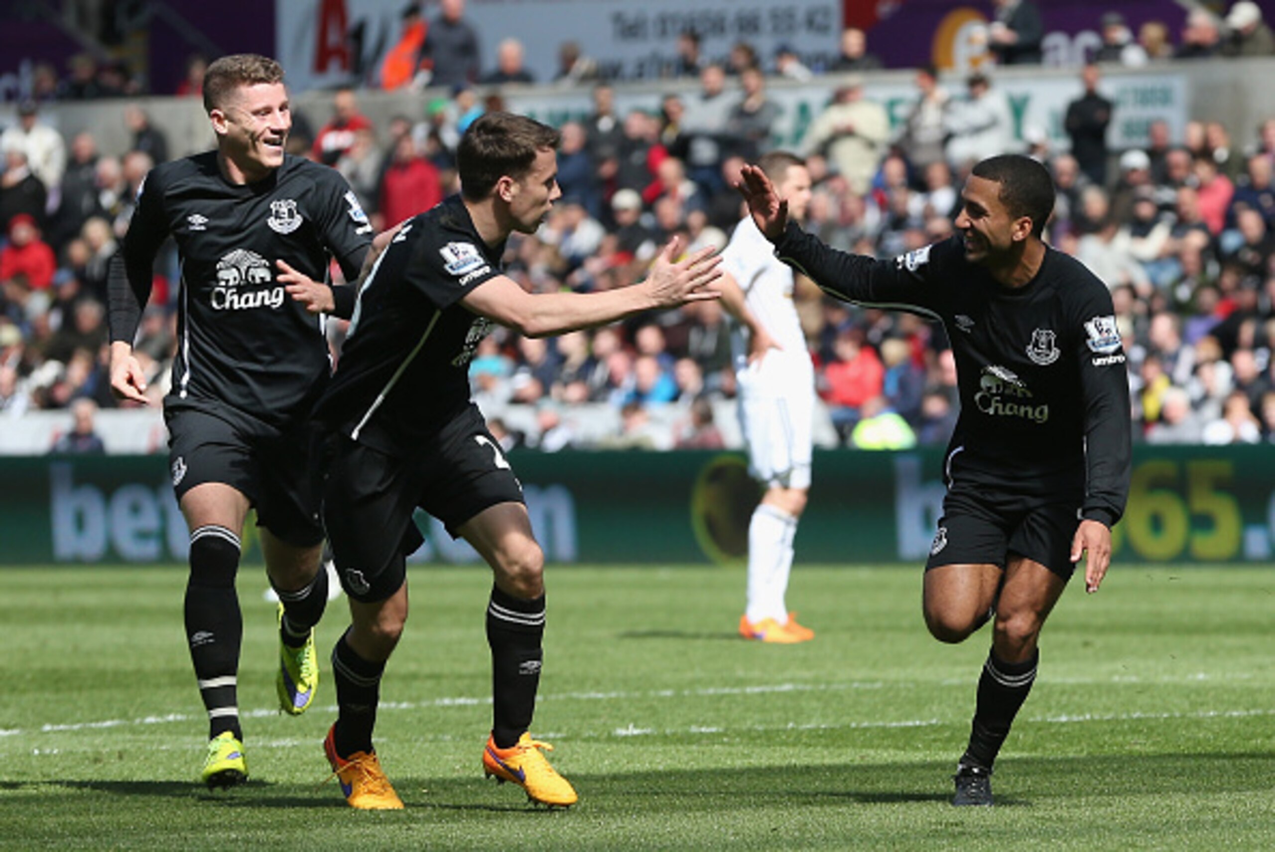 SWANSEA, WALES - APRIL 11: Aaron Lennon of Everton (R) celebrates scoring the opening goal with Seamus Coleman and Ross Barkley of Everton  during the Barclays Premier League match between Swansea City and Everton at Liberty Stadium on April 11, 2015 in S