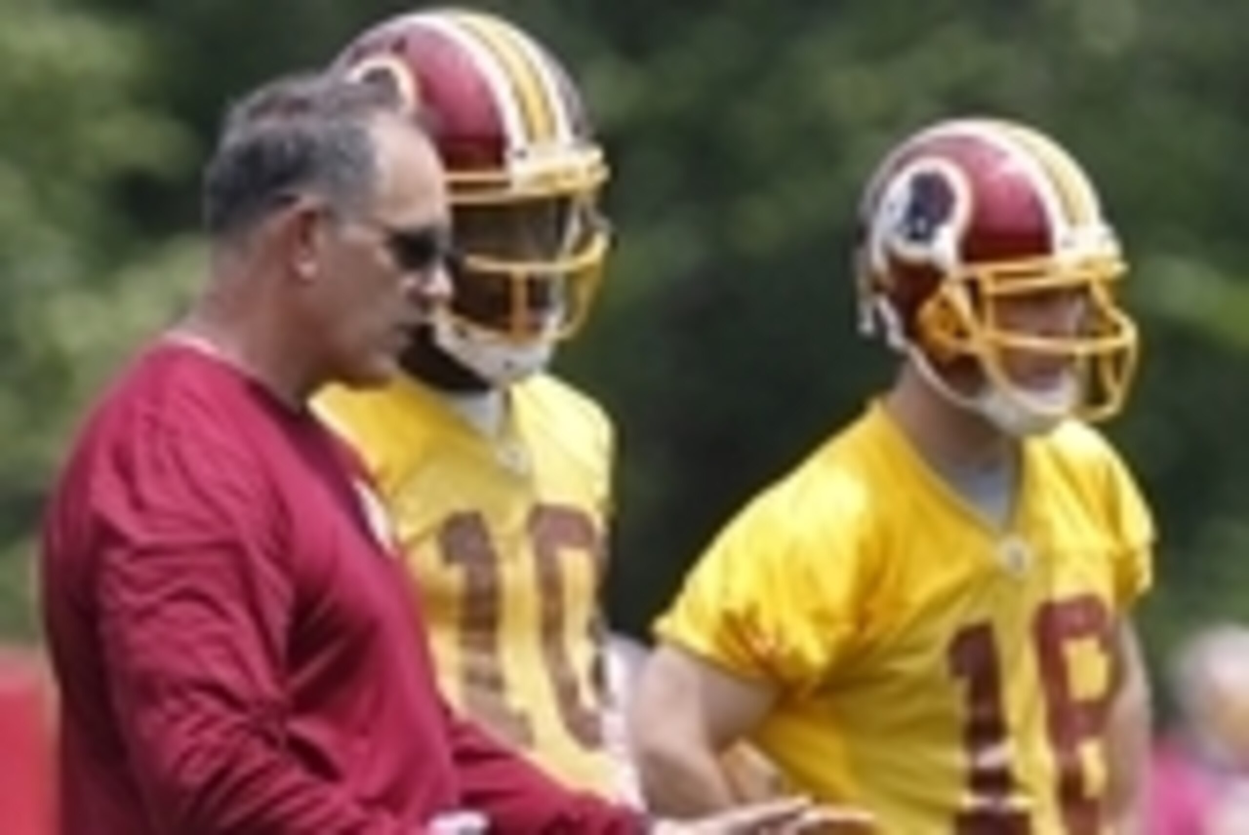 Jun 16, 2015; Ashburn, VA, USA; Washington Redskins quarterbacks coach Matt Cavenaugh (L) talks with Redskins quarterback Robert Griffin III (10) during day one of Redskins Minicamp at Redskins Park. Mandatory Credit: Geoff Burke-USA TODAY Sports