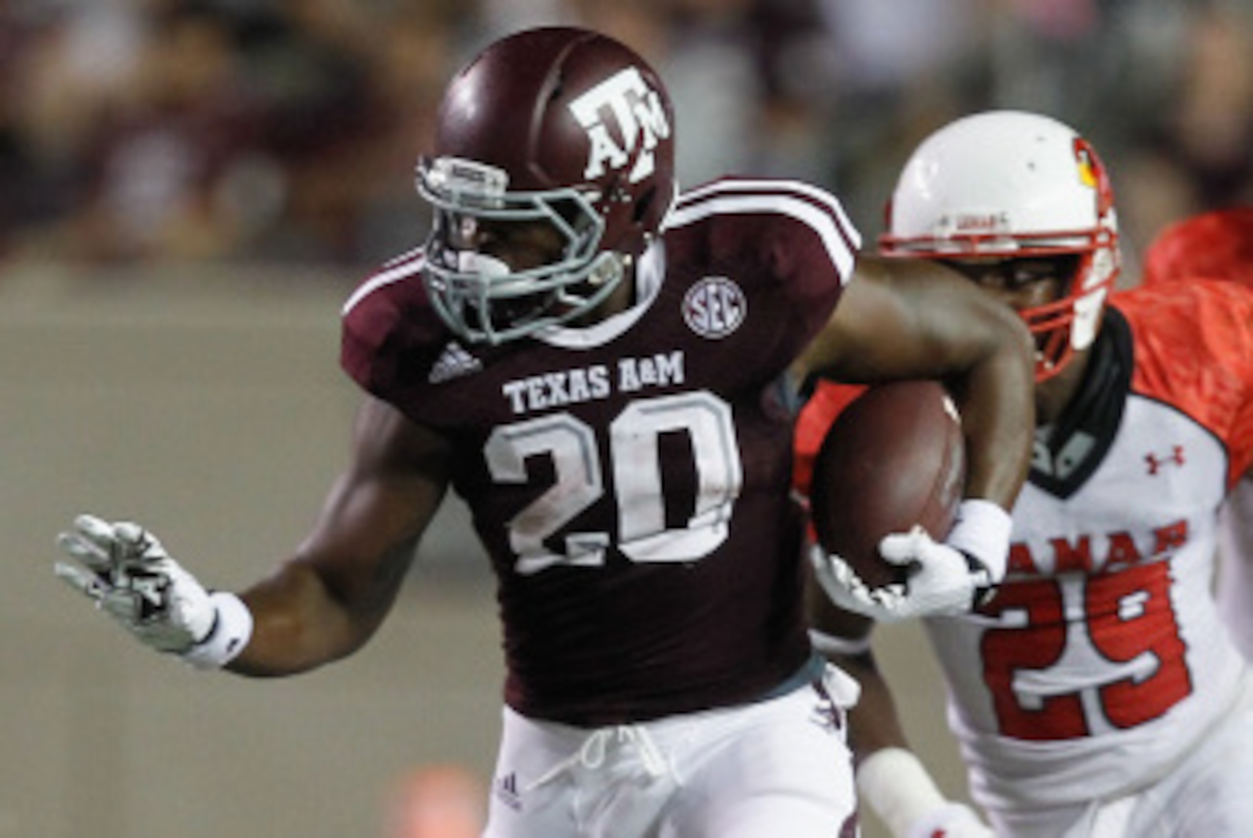 COLLEGE STATION, TX - SEPTEMBER 06: James White #20 of the Texas A&M Aggies rushes past Xavier Bethany #29 of the Lamar Cardinals at Kyle Field on September 6, 2014 in College Station, Texas. (Photo by Bob Levey/Getty Images)