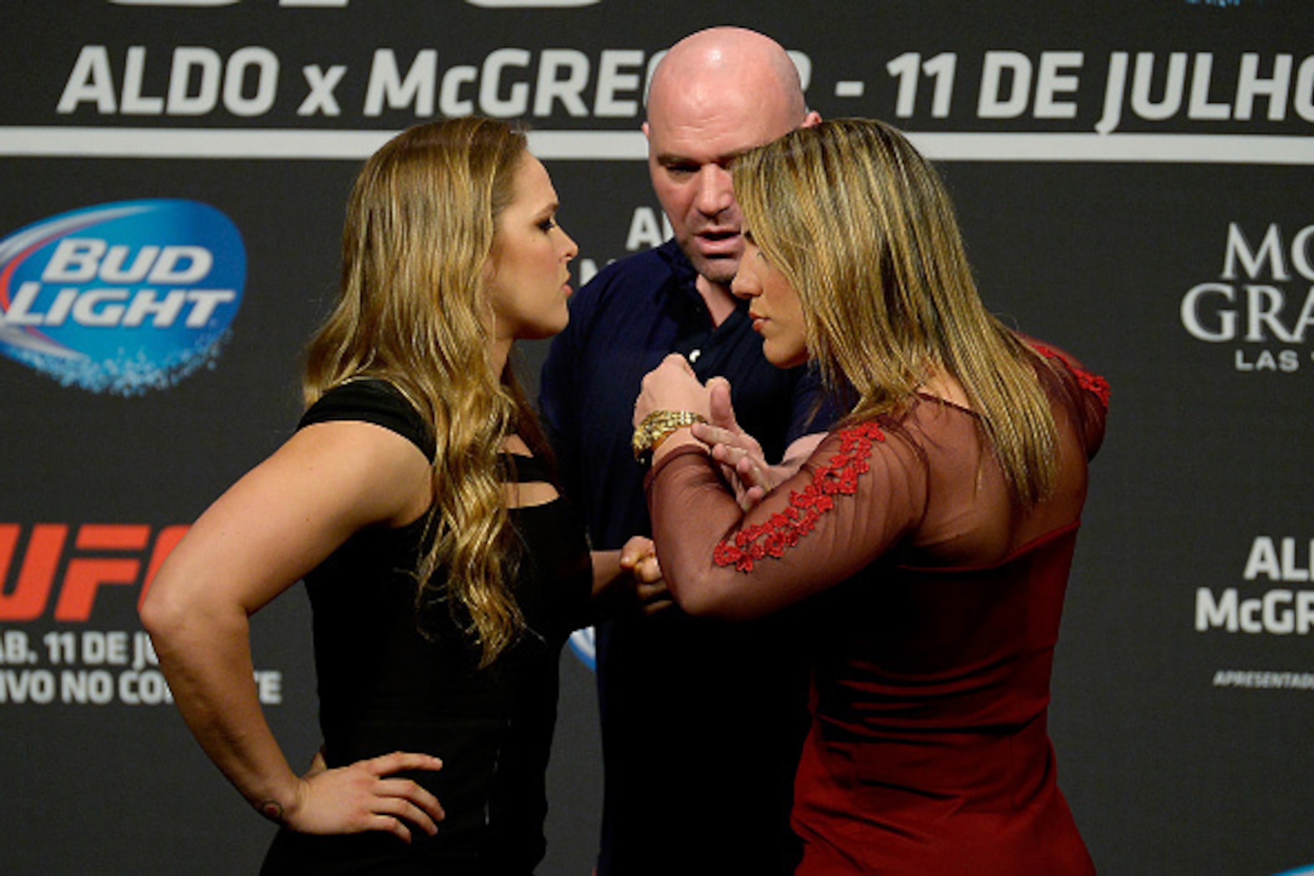RIO DE JANEIRO, BRAZIL - MARCH 20:  UFC Women's Bantamweight Champion Ronda Rousey of the United States and Bethe Correia of Brazil face off as UFC President Dana White (C) stands in during the 189 World Media Tour Launch press conference at Maracanazinho