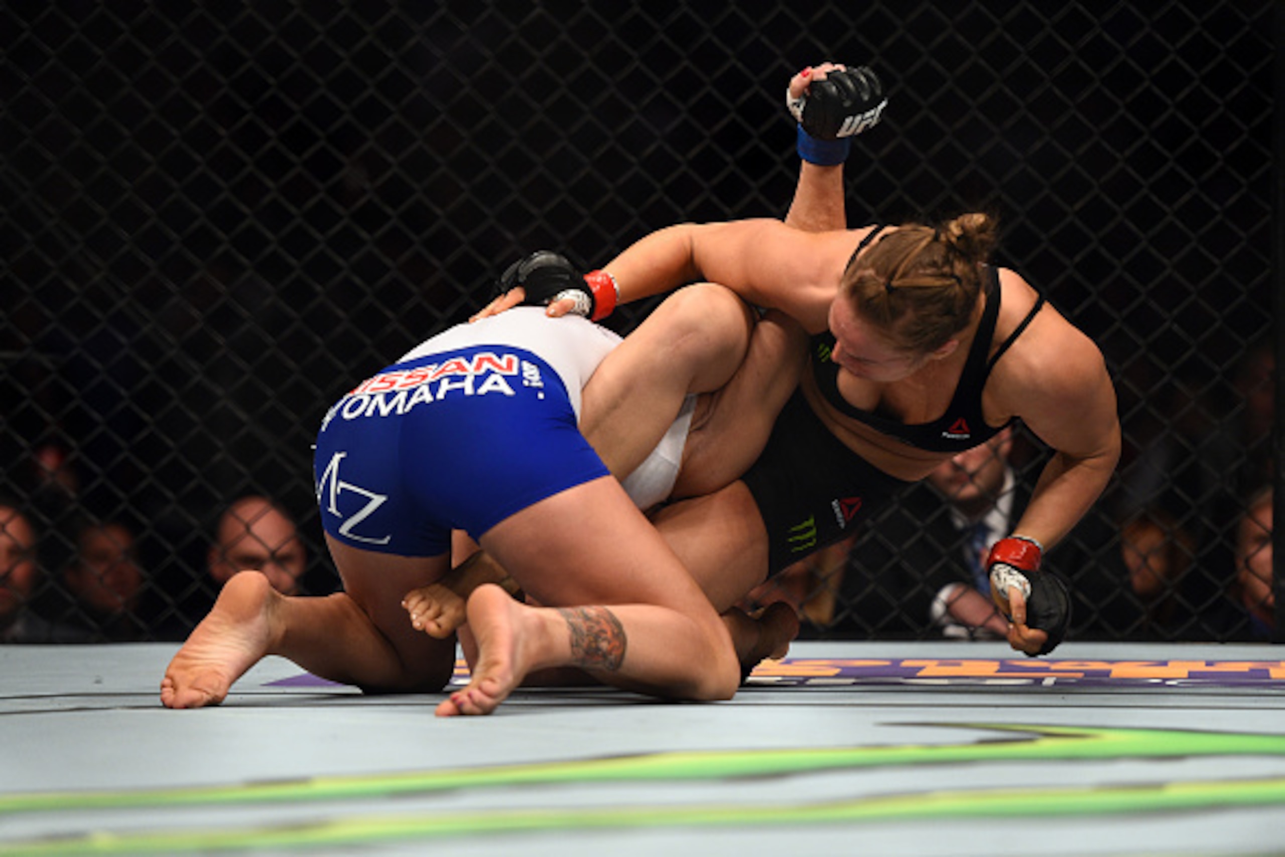 LOS ANGELES, CA - FEBRUARY 28:  (R-L) Ronda Rousey sets up and armbar against Cat Zingano in their UFC women's bantamweight championship bout during the UFC 184 event at the Staples Center on February 28, 2015 in Los Angeles, California. (Photo by Jeff Bo