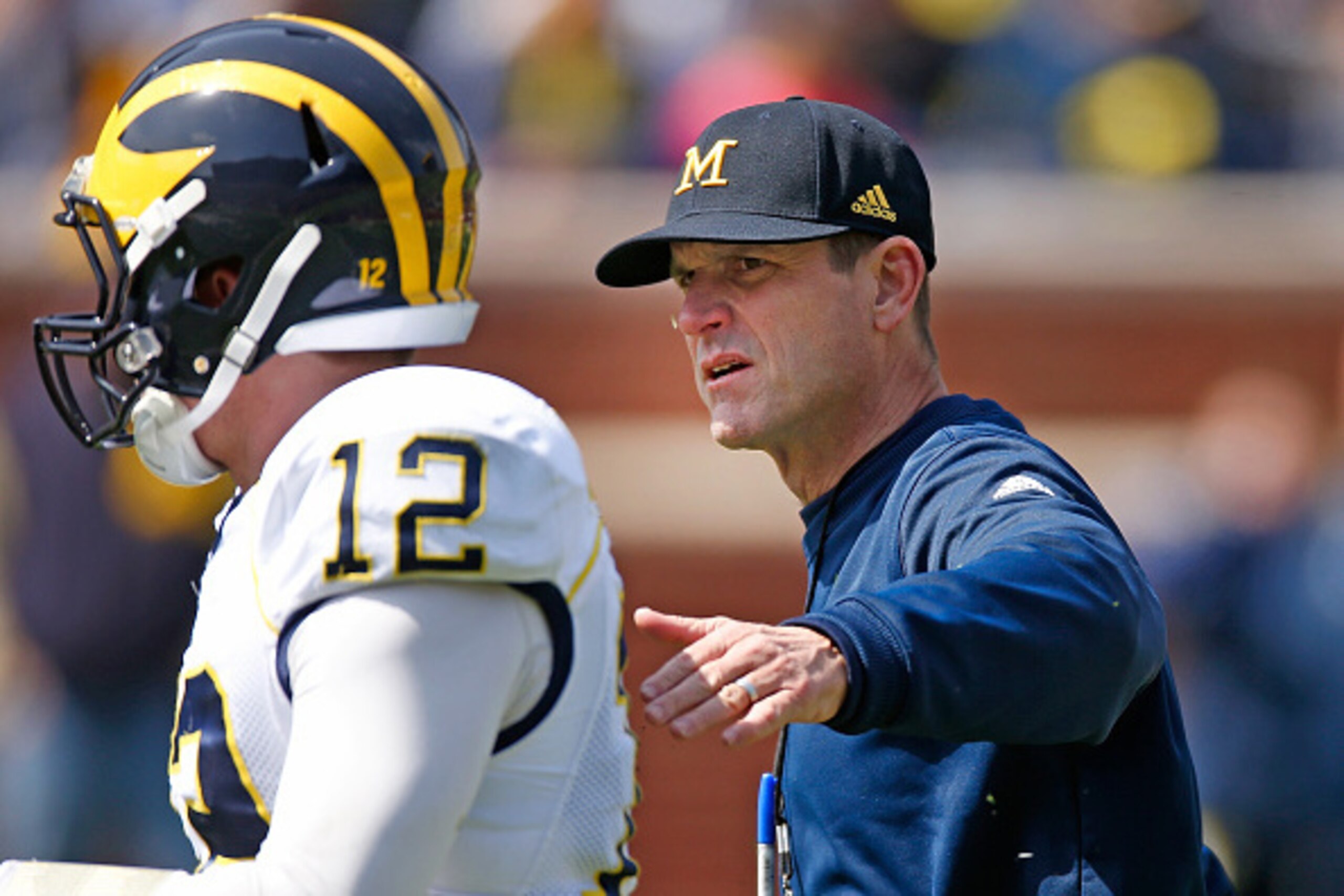 ANN ARBOR, MI - APRIL 04: Head coach Jim Harbaugh of the Michigan Wolverines talks with Alex Malzone #12 during the Michigan Football Spring Game on April 4, 2015 at Michigan Stadium in Ann Arbor, Michigan.  (Photo by Gregory Shamus/Getty Images)