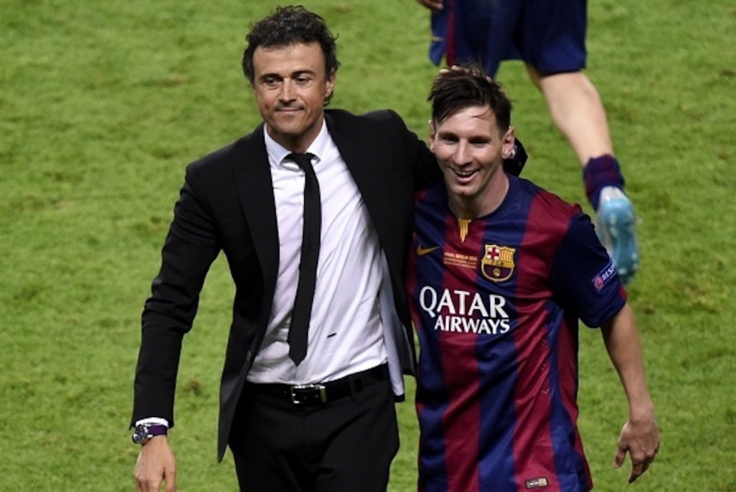 Barcelona's coach Luis Enrique and Barcelona's Argentinian forward Lionel Messi (R) celebrate after winning the UEFA Champions League Final football match between Juventus and FC Barcelona at the Olympic Stadium in Berlin on June 6, 2015.            AFP P