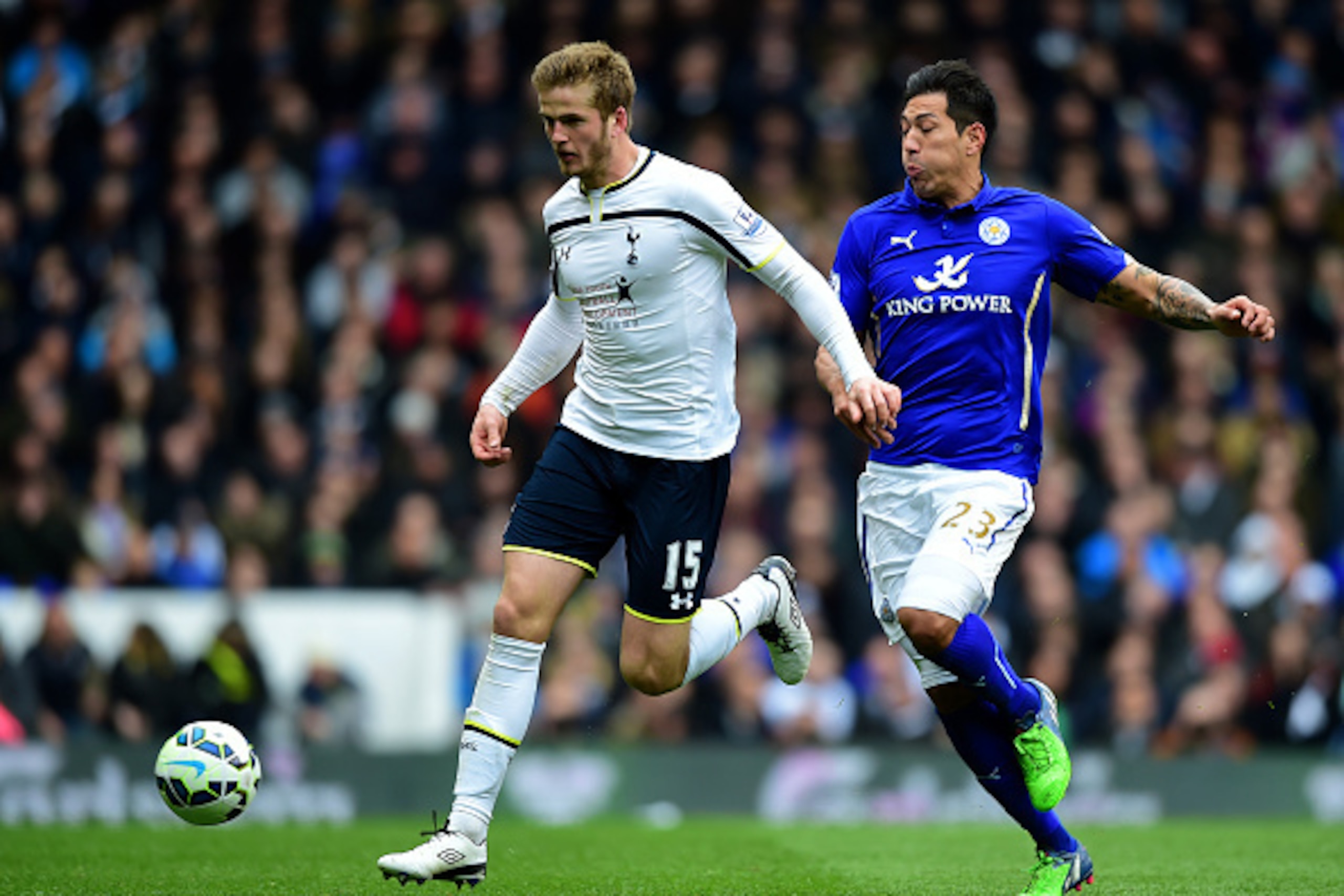 LONDON, ENGLAND - MARCH 21:  Eric Dier of Spurs runs with the ball under pressure from Leonardo Ulloa of Leicester City during the Barclays Premier League match between Tottenham Hotspur and Leicester City at White Hart Lane on March 21, 2015 in London, E