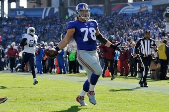 NASHVILLE, TN - DECEMBER 07:  Markus Kuhn #78 of the New York Giants carries a fumble into the end zone for a touchdown against the Tennessee Titans during the first quarter in a game at LP Field on December 7, 2014 in Nashville, Tennessee.  (Photo by Fre