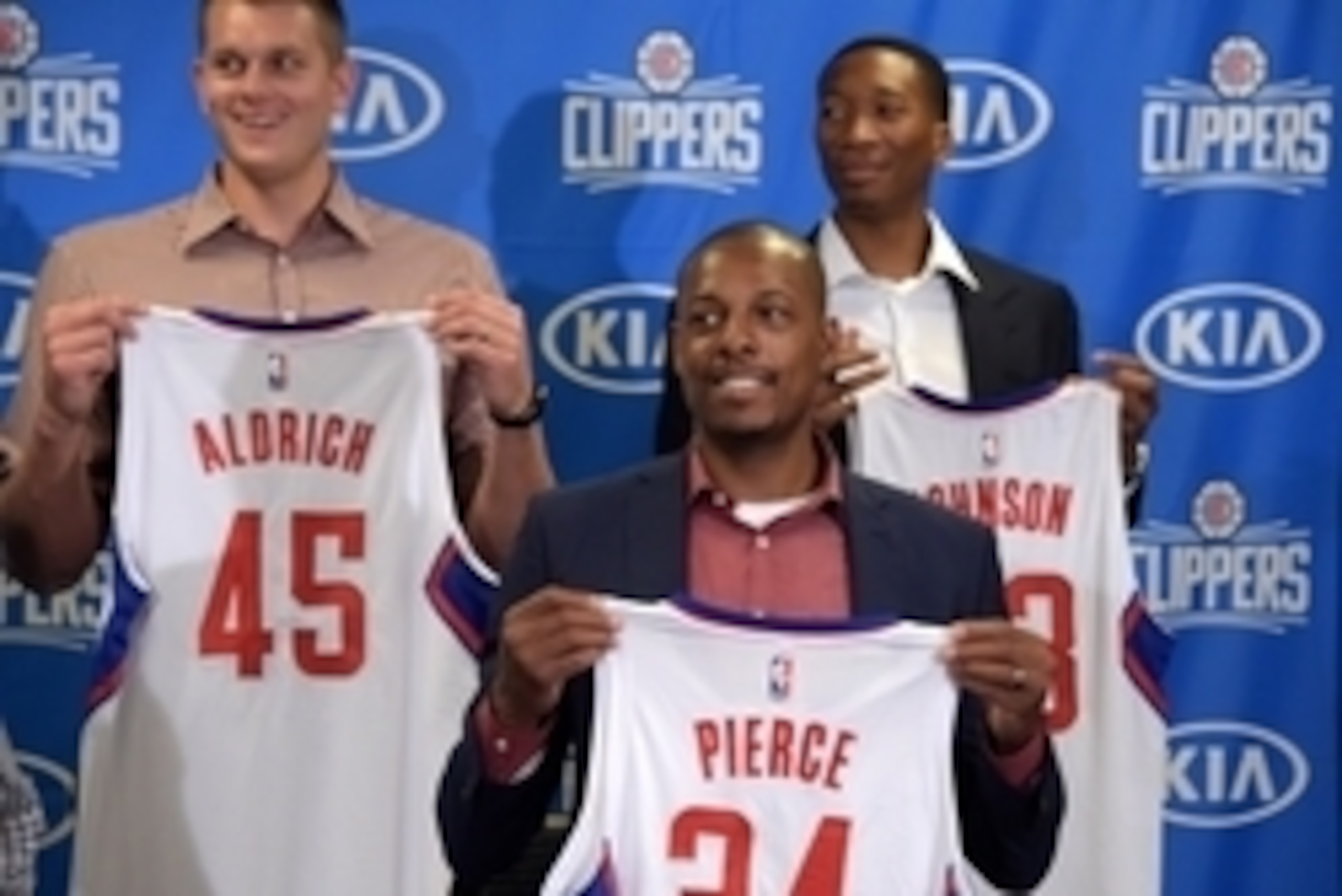 Jul 21, 2015; Los Angeles, CA, USA; Los Angeles Clippers players Cole Aldrich (45), Paul Pierce (34) and Wesley Johnson (33) pose with jerseys at press conference at Staples Center. Mandatory Credit: Kirby Lee-USA TODAY Sports