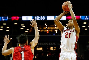 NEW YORK, NY - NOVEMBER 21: Anthony Brown #21 of the Stanford Cardinal takes a shot as Rashad Vaughn #1 the UNLV Rebels defends during the first half of a game in the Coaches vs Cancer Classic men's basketball tournament at Barclays Center on November 21,