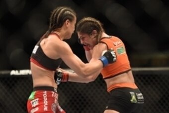 August 30, 2014; Sacramento, CA, USA; Bethe Correia (red gloves) fights against Shayna Baszler (blue gloves) during the women   s bantamweight bout of UFC 177 at Sleep Train Arena. Mandatory Credit: Kyle Terada-USA TODAY Sports