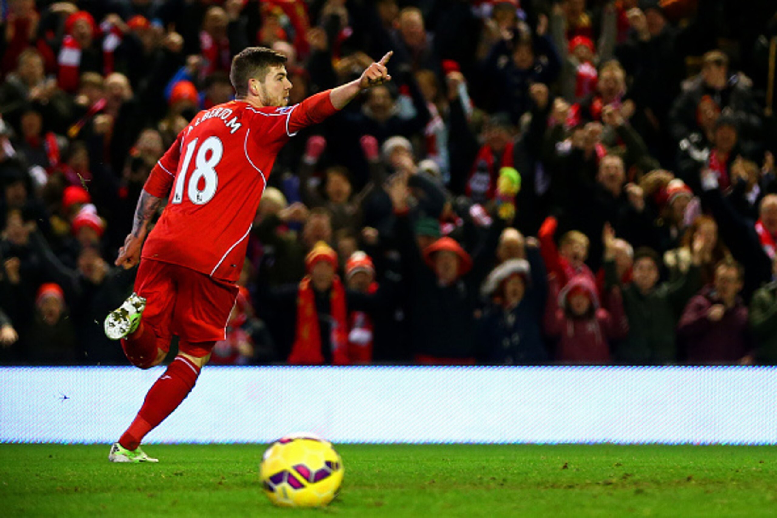 LIVERPOOL, ENGLAND - DECEMBER 29:  Alberto Moreno of Liverpool celebrates after scoring the opening goal during the Barclays Premier League match between Liverpool and Swansea City at Anfield on December 29, 2014 in Liverpool, England.  (Photo by Clive Br