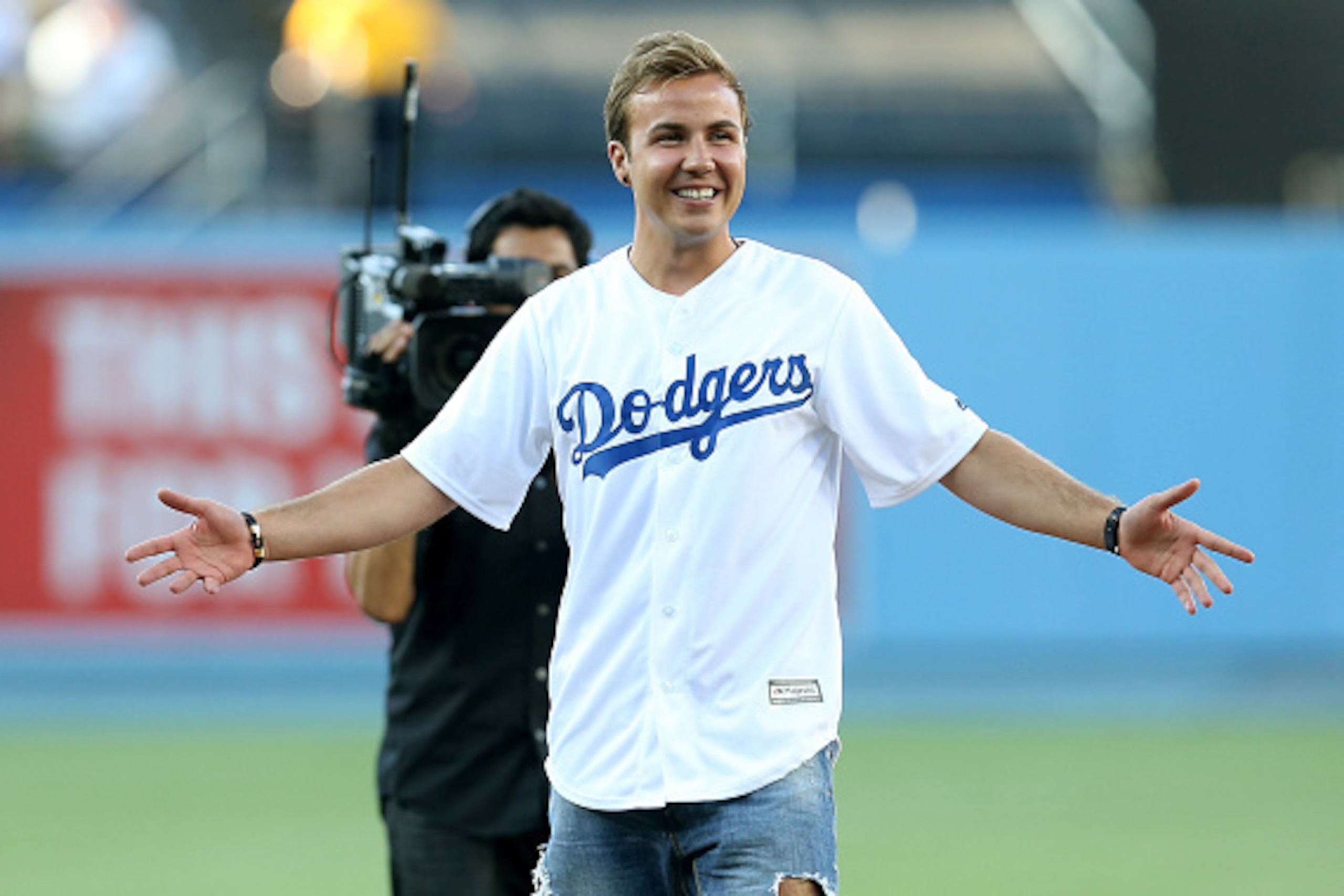LOS ANGELES, CA - JULY 03: FC Bayern Munich soccer player Mario Gotze reacts after throwing out the ceremonial first pitch before the game between the New York Mets the Los Angeles Dodgers at Dodger Stadium on July 3, 2015 in Los Angeles, California. ( LOS ANGELES, CA - JULY 03: FC Bayern Munich soccer player Mario Gotze reacts after throwing out the ceremonial first pitch before the game between the New York Mets the Los Angeles Dodgers at Dodger Stadium on July 3, 2015 in Los Angeles, California. (