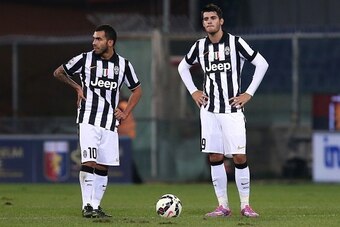 Juventus' Argentinian forward Carlos Tevez and Juventus' forward Alvaro Morata of Spain react during the Italian Serie A football match Genoa Vs Juventus on October 29, 2014 at Luigi Ferraris Stadium in Genoa.  AFP PHOTO / MARCO BERTORELLO        (Photo c