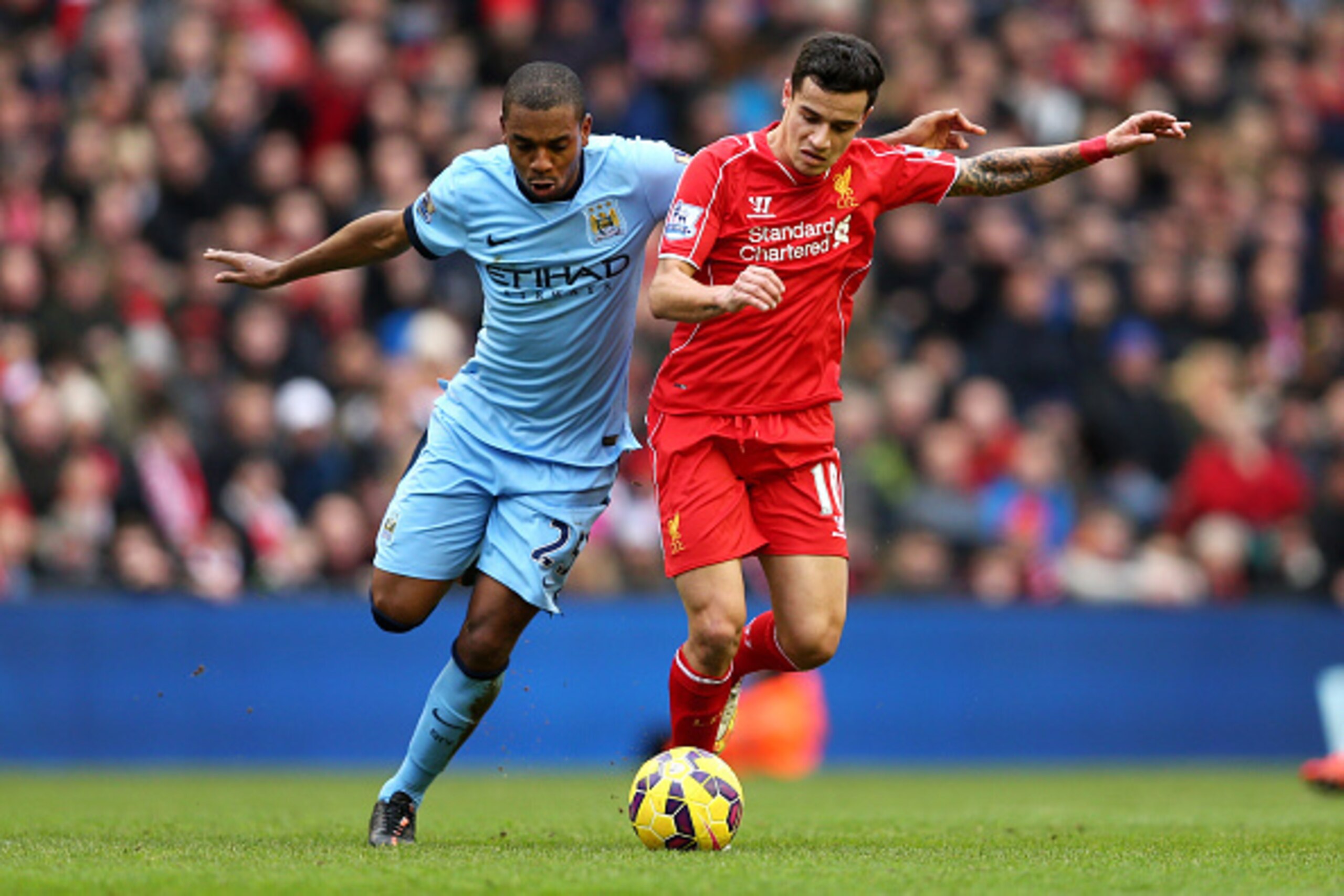 LIVERPOOL, ENGLAND - MARCH 01:  Philippe Coutinho of Liverpool is challenged by Fernandinho of Manchester City during the Barclays Premier League match between Liverpool and Manchester City at Anfield on March 1, 2015 in Liverpool, England.  (Photo by Cli