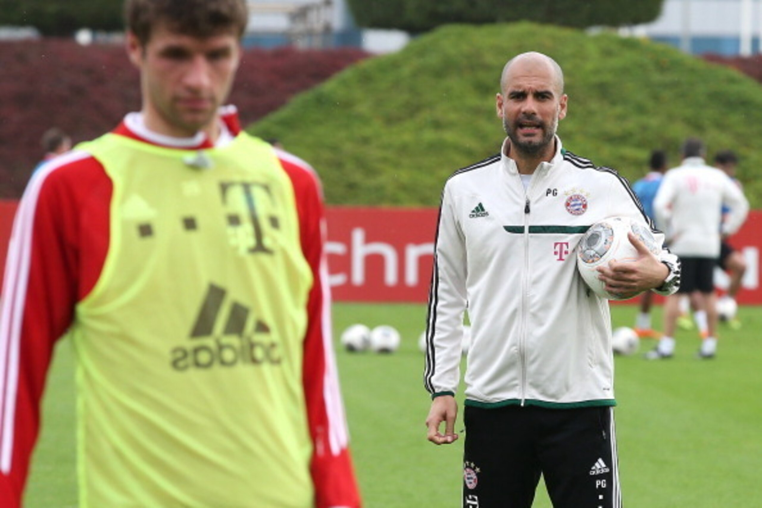DOHA, QATAR - JANUARY 6: Pep Guardiola, coach of Bayern Muenchen directs the practice session, here with Thomas Muller, on day 2 of Bayern Muenchen Training Camp, held at the Aspire Academy for Sports Excellence on January 6, 2013 in Doha, Qatar. (Photo b