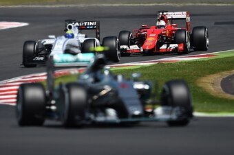 Mercedes AMG Petronas F1 Team's German driver Nico Rosberg (front), Williams Martini Racing's Brazilian driver Felipe Massa (C) and Ferrari's German driver Sebastian Vettel  drive during the qualifying session at the Silverstone circuit in Silverstone on 