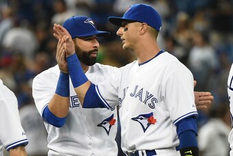 Jul 29, 2015; Toronto, Ontario, CAN;  Toronto Blue Jays shortstop Troy Tulowitzki (right) gets a hand slap and a backpat from designated hitter Jose Bautista (left) as they celebrate an 8-2 win over Philadelphia Phillies at Rogers Centre. Mandatory Credit