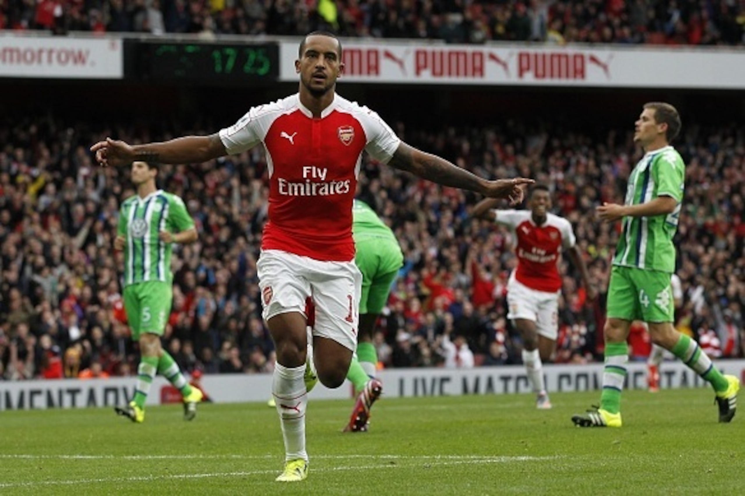 Arsenal's English midfielder Theo Walcott celebrates scoring the opening goal of the pre-season friendly football match between Arsenal and Wolfsburg at The Emirates Stadium in north London on July 26, 2015, the game is one of four matches played over two