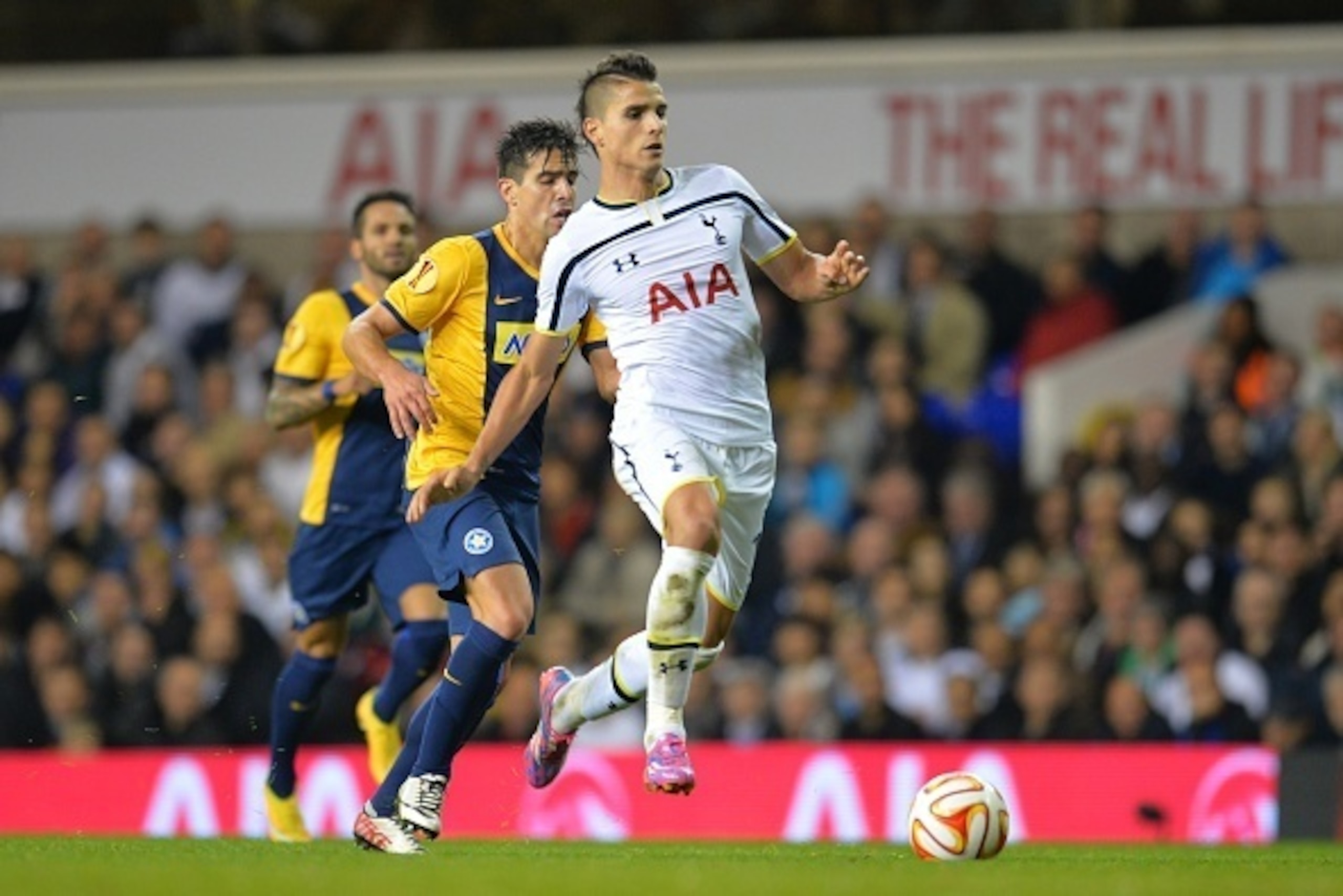 Tottenham Hotspur's Argentinian midfielder Erik Lamela (R) runs with the ball during the UEFA Europa League group C football match between Tottenham Hotspur and Asteras Tripolis at White Hart Lane in north London, on October 23, 2014. AFP PHOTO / GLYN KIR