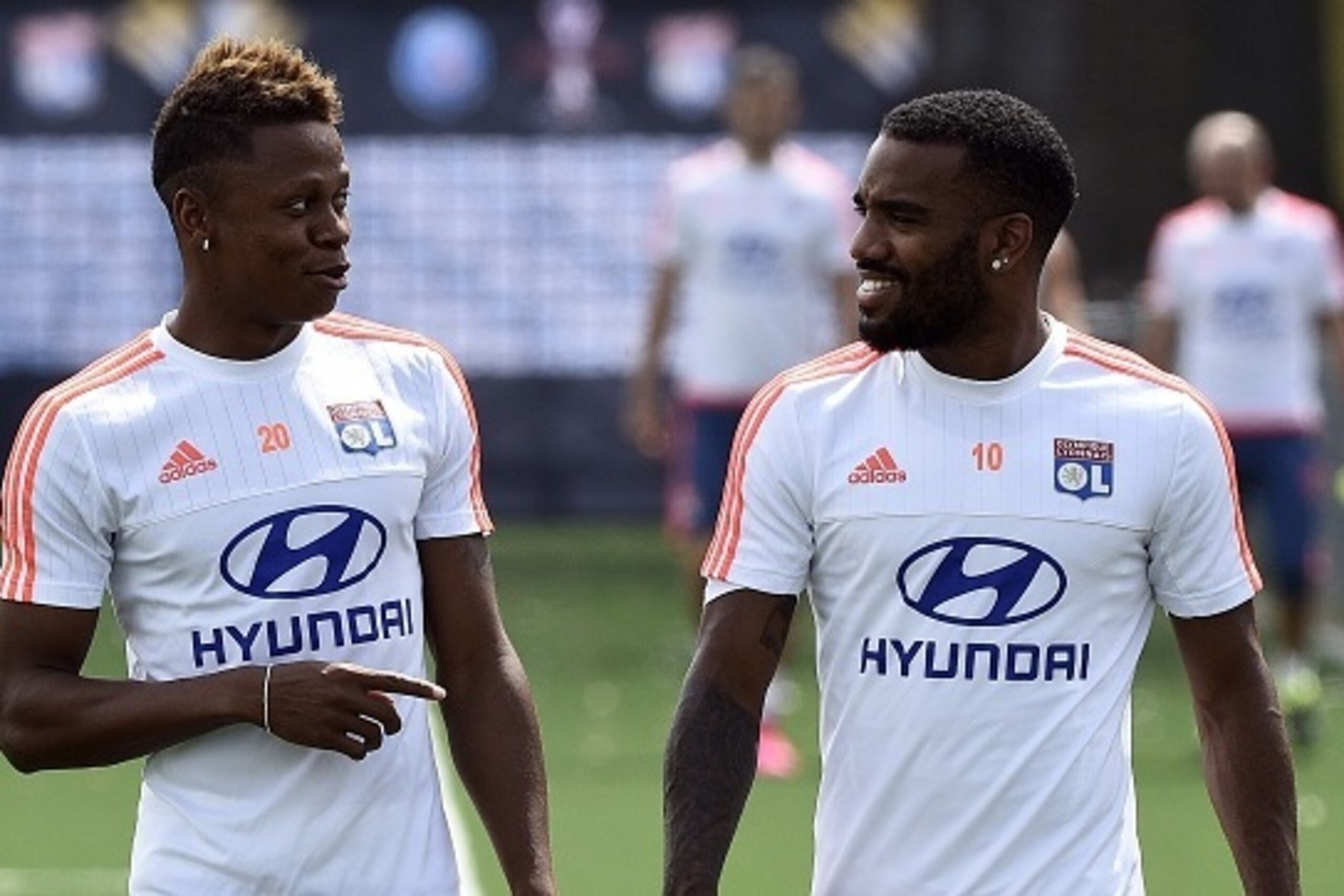 Lyon's French forward Alexandre Lacazette (R) speaks with Lyon's Cameroon forward Clinton Njie during a training session at Saputo stadium in Montreal , Canada on July 30, 2015 two days ahead of French Trophy of Champions football match against Paris-Sain