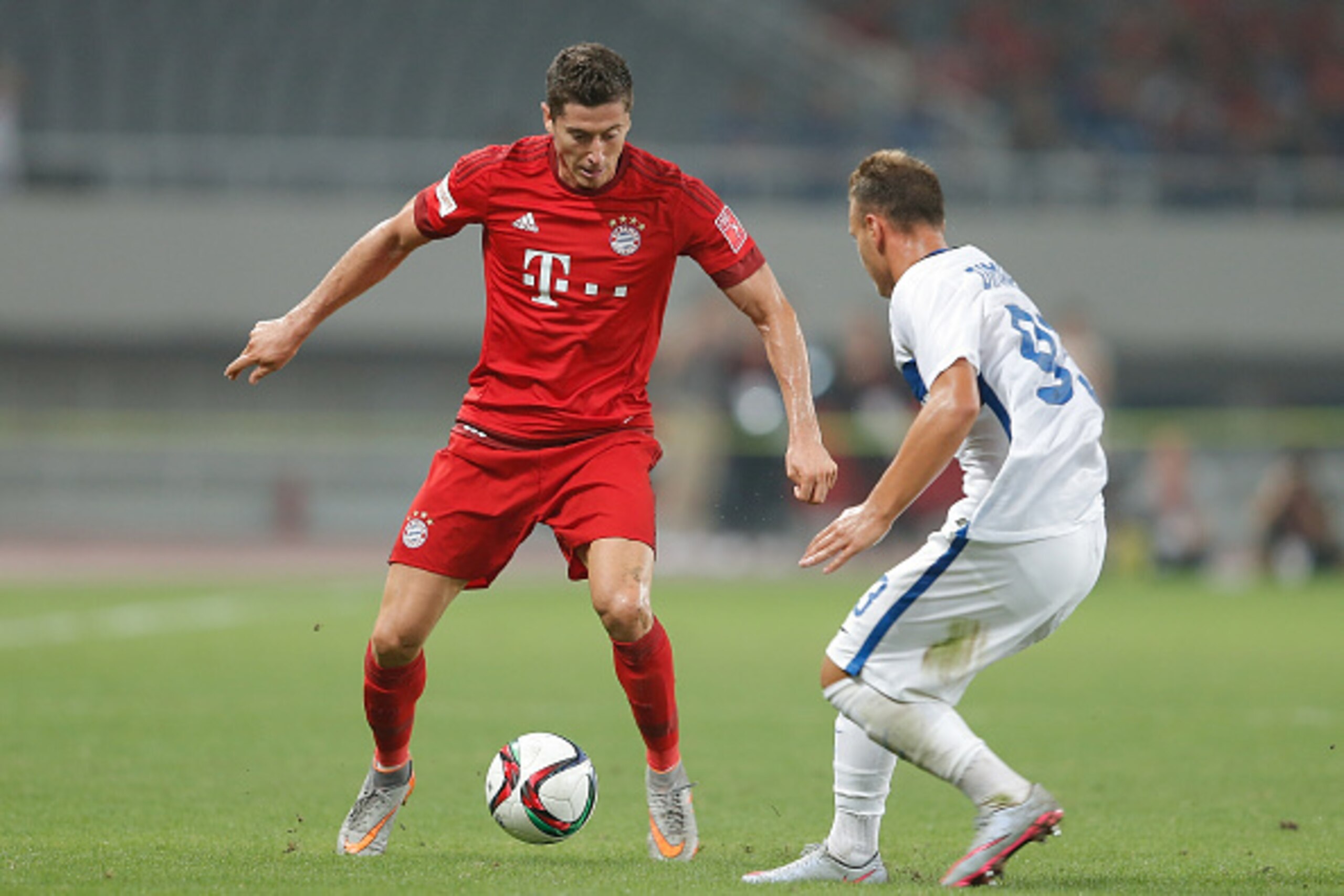 SHANGHAI, CHINA - JULY 21:  Robert Lewandowski (L) of FC Bayern Muenchen challenges federico Dimarco of FC Internazionale during the international friendly match between FC Bayern Muenchen and Inter Milan of the Audi Football Summit 2015 at Shanghai Stadi