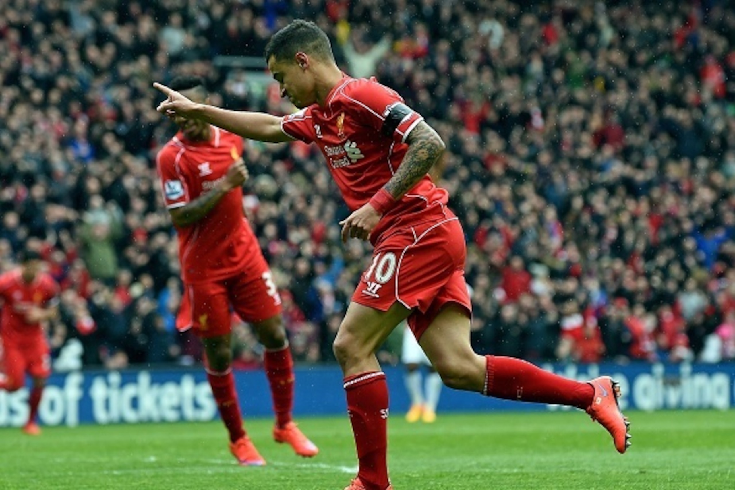 Liverpool's Brazilian midfielder Philippe Coutinho (R) celebrates scoring during the English Premier League football match between Liverpool and Queens Park Rangers at the Anfield stadium in Liverpool, northwest England, on May 2, 2015. AFP PHOTO / PAUL Liverpool's Brazilian midfielder Philippe Coutinho (R) celebrates scoring during the English Premier League football match between Liverpool and Queens Park Rangers at the Anfield stadium in Liverpool, northwest England, on May 2, 2015. AFP PHOTO / PAUL