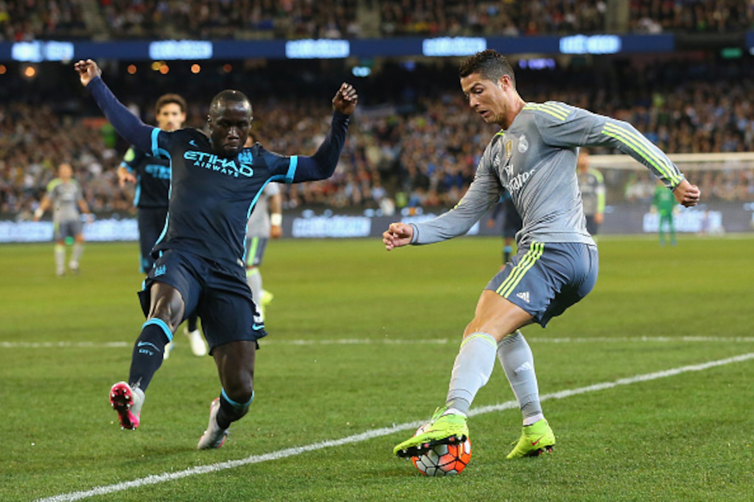 MELBOURNE, AUSTRALIA - JULY 24:  Bacary Sagna of Manchester City and Cristiano Ronaldo of Real Madrid compete for the ball during the International Champions Cup match between Real Madrid and Manchester City at Melbourne Cricket Ground on July 24, 2015 in