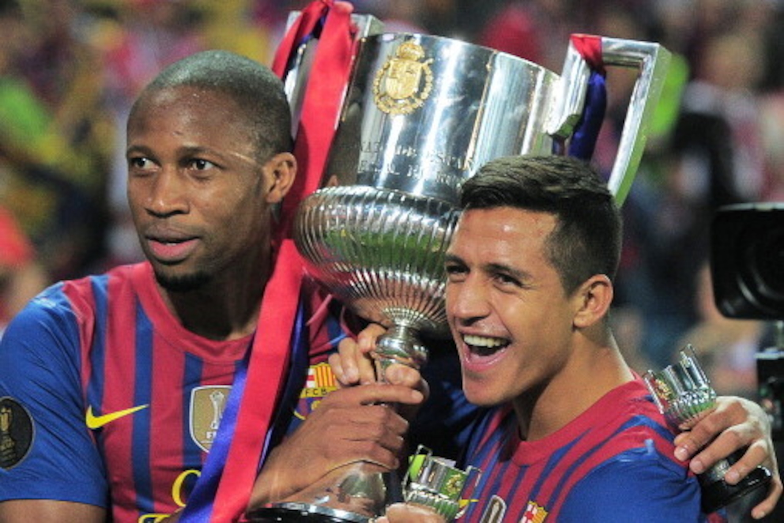 Barcelona's Malian midfielder Seydou Keita (L) and Barcelona's Chilean forward Alexis Sanchez (R) pose with the Cup after winning the Spanish King's Cup final match between Athletic Bilbao and FC Barcelona on May 25, 2012 at the Vicente Calderon stadium i