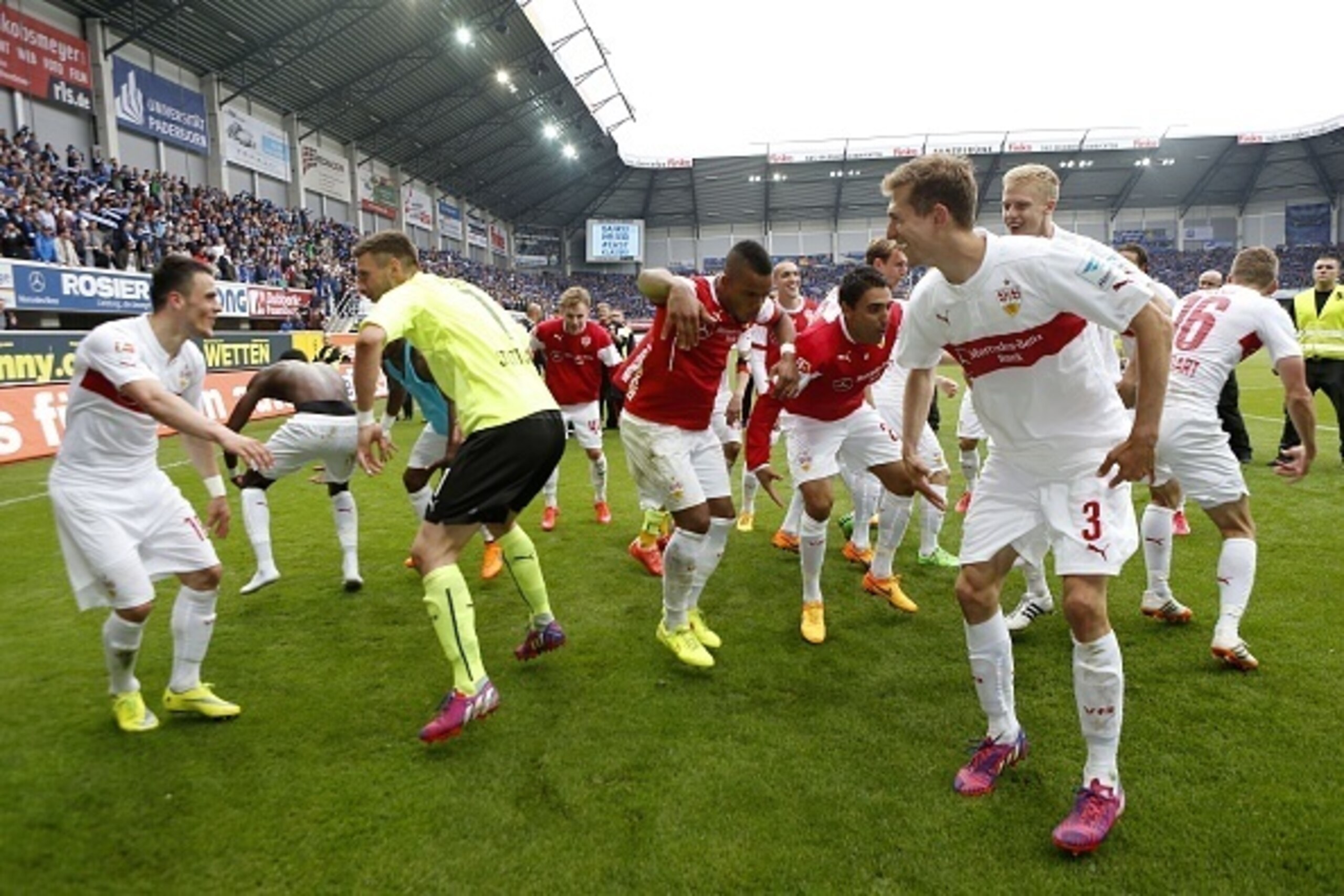 Stuttgart players celebrate staying up in the 1st divistion after the German first division Bundesliga football match between SC Paderborn and VfB Stuttgart at the Benteler Arena in Paderborn, western Germany, on May 23, 2015. AFP PHOTO / NORBERT SCHMIDT

