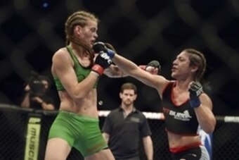 Apr 26, 2014; Baltimore, MD, USA;  Bethe Correia (right) lands a head shot on Jessamyn Duke during the second round  in UFC 172 at Baltimore Arena. Correia defeated Duke by judges decision.  Mandatory Credit: Tommy Gilligan-USA TODAY Sports